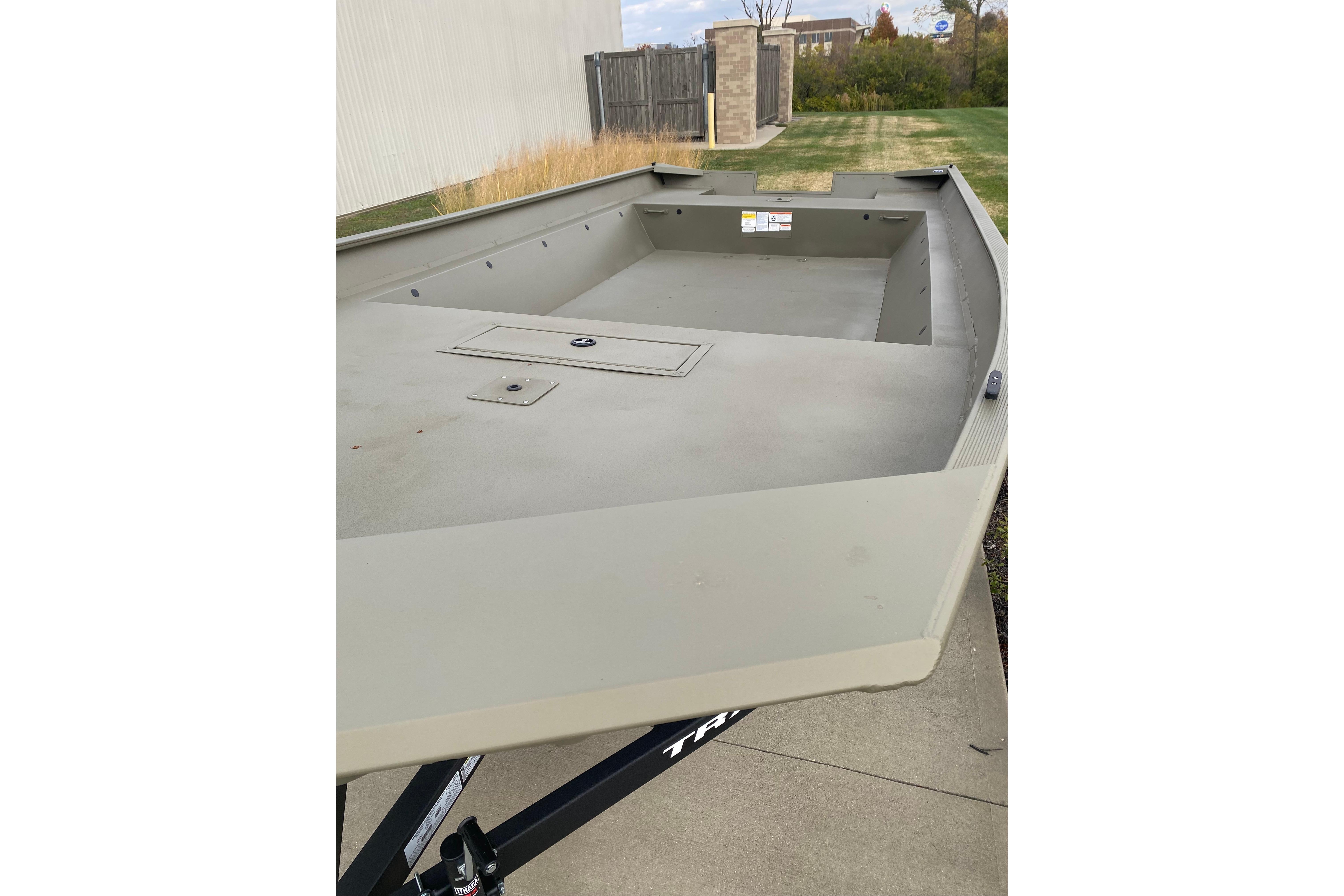2026 Tracker Grizzly 2072 Utility boat on trailer, parked outdoors.