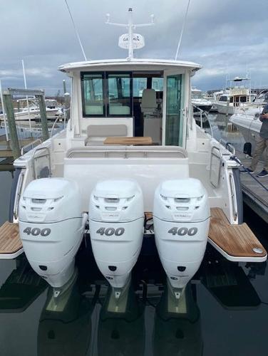2025 Back Cove 39O boat with triple 400 horsepower outboard engines docked in a marina.