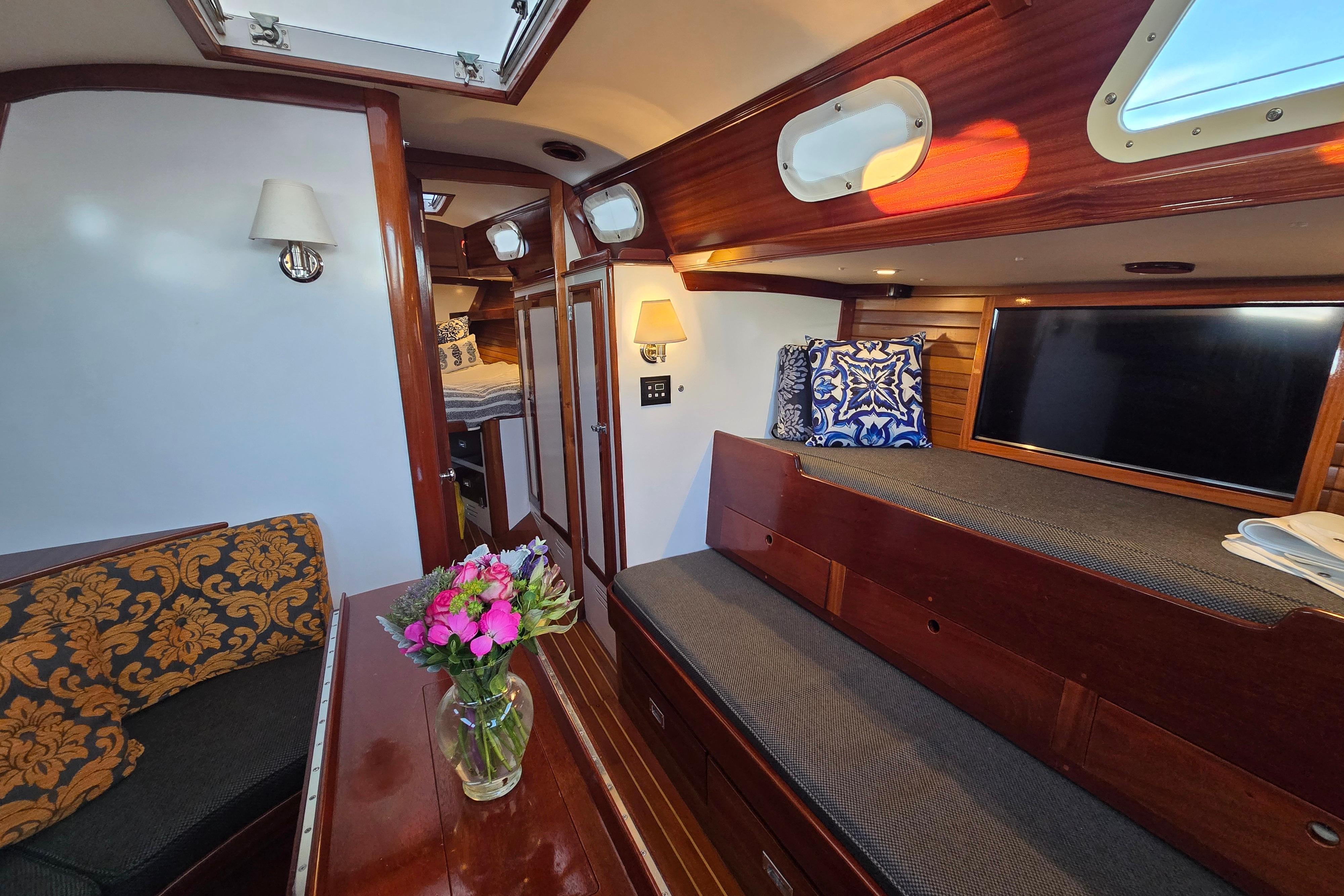 Interior of a 1970 Hinckley Bermuda 40 yacht with elegant wood finish and cozy seating.