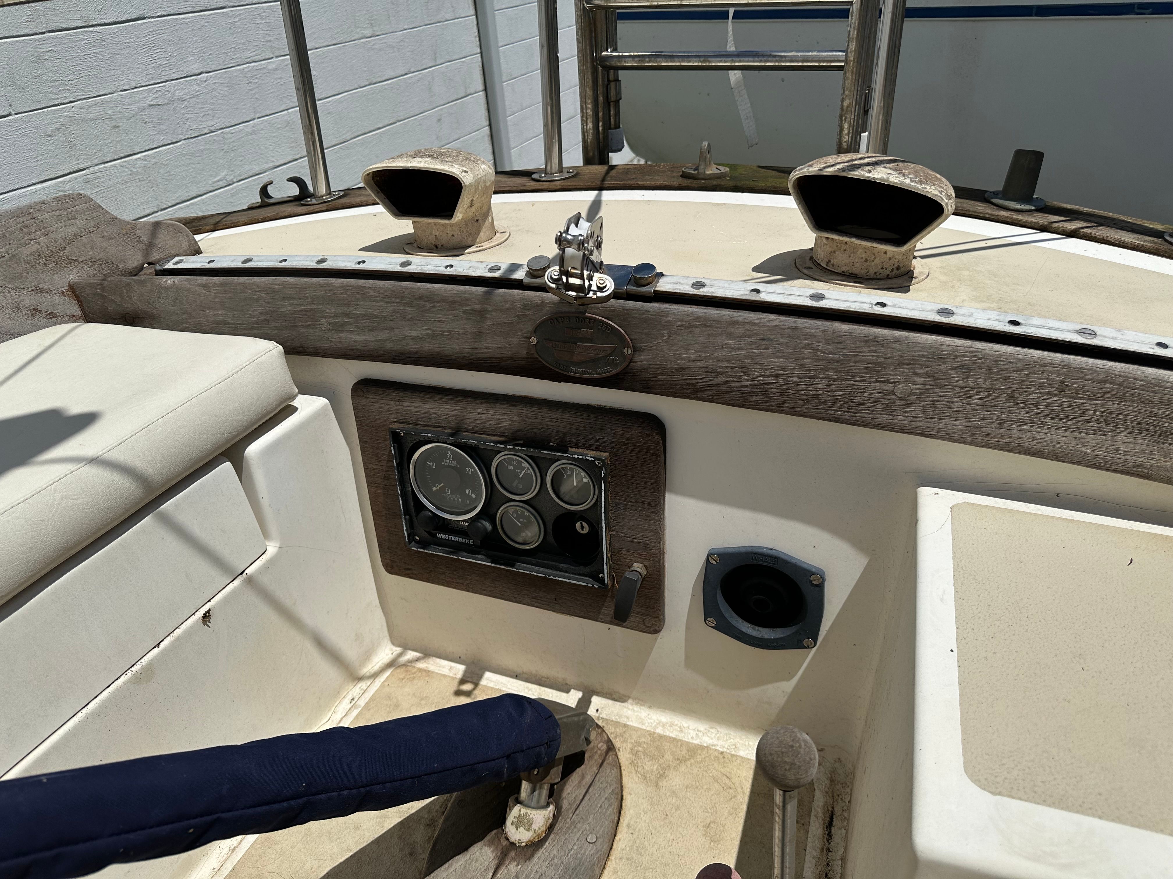 Cockpit of a 1985 Cape Dory 25D with instruments and wood trim.