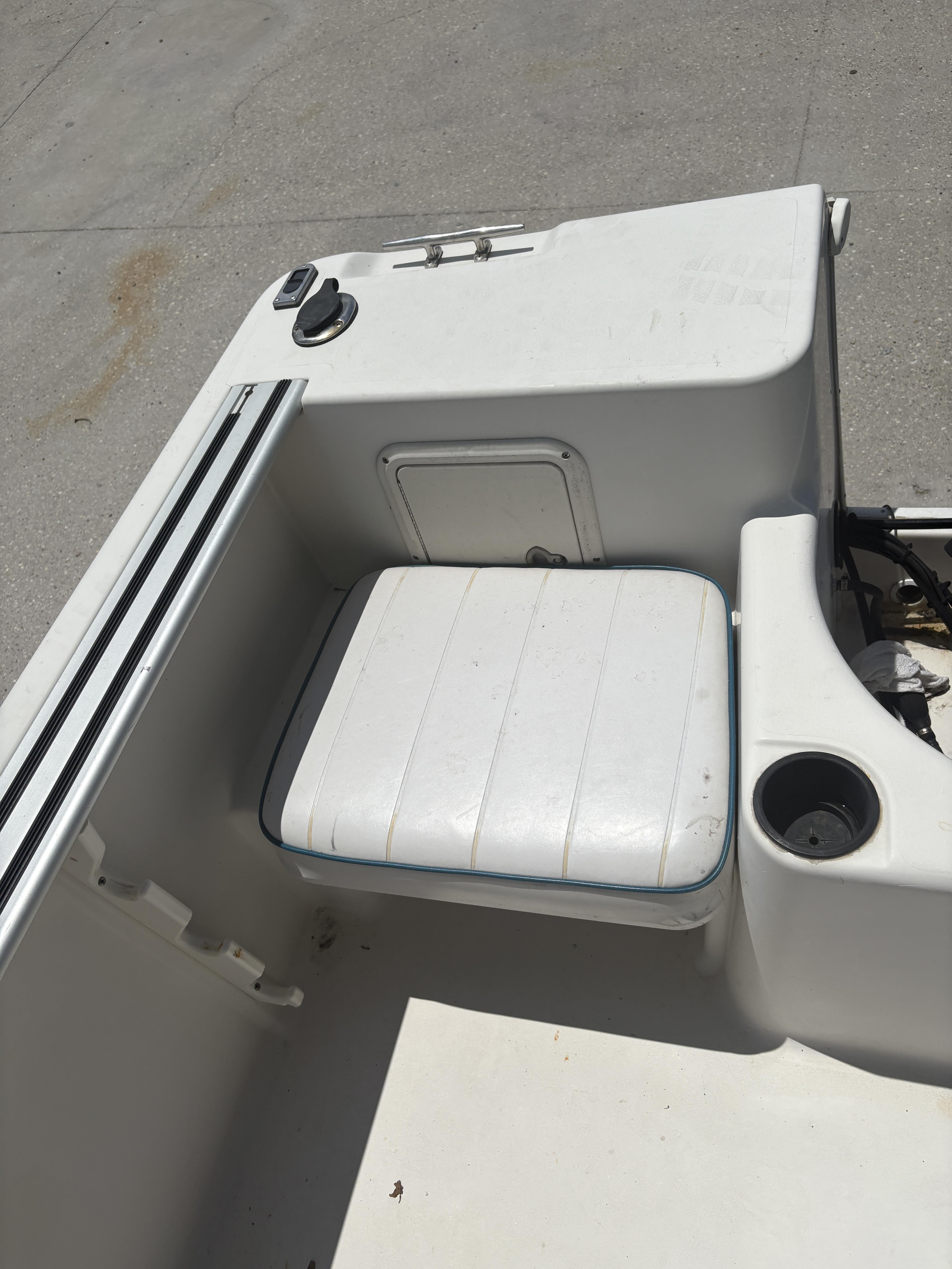 1996 Pro-Line 202 boat interior with white seating and storage compartment.