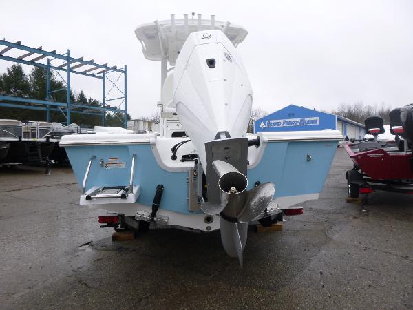 2025 Sea Pro 250 Bay boat, rear view, showcasing outboard motor and light blue hull.