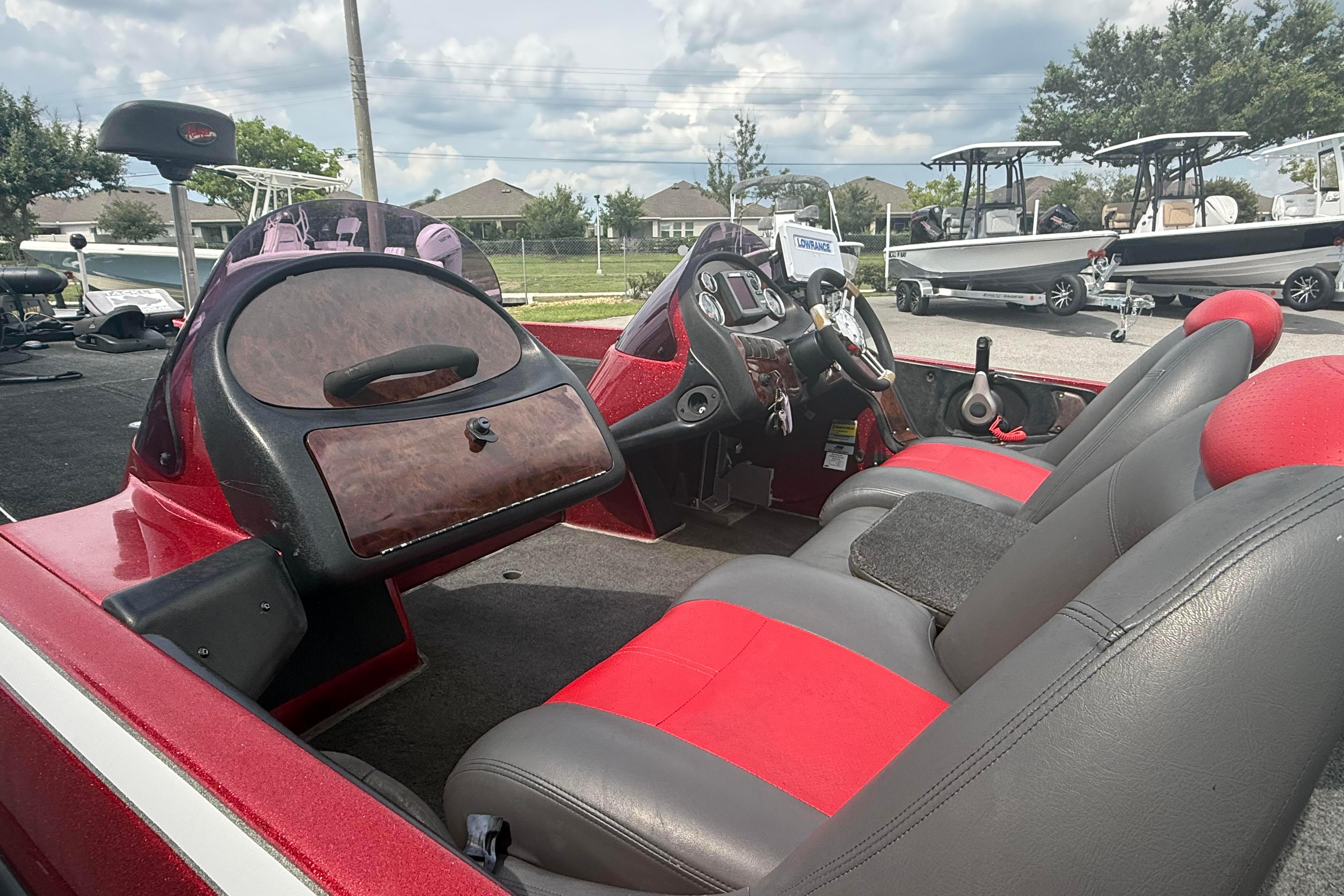 2007 Ranger 519 VX boat interior with red and gray seating, steering console, and dashboard.