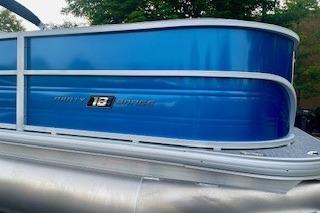 2026 Sun Tracker Party Barge 18 DLX pontoon boat with blue exterior.