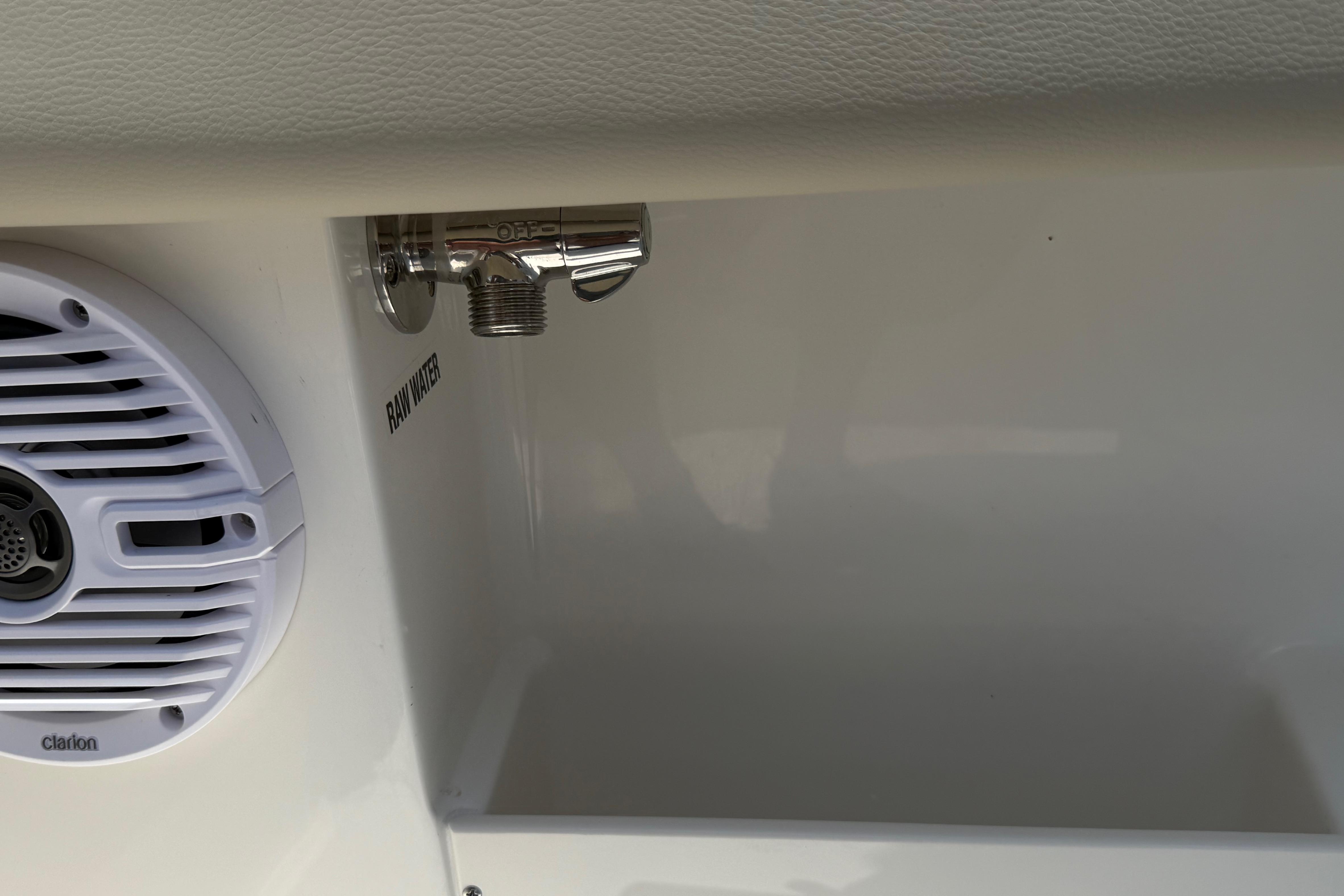 2027 Key West 249 FS boat detail with speaker and raw water outlet.