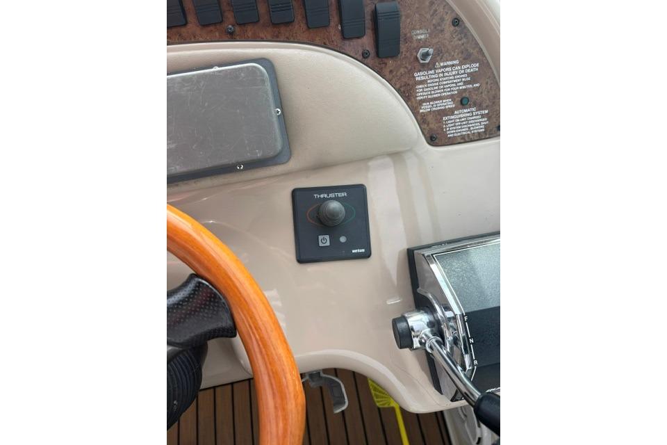 Control panel of a 2000 Sea Ray Sundancer 310 boat with thruster joystick.