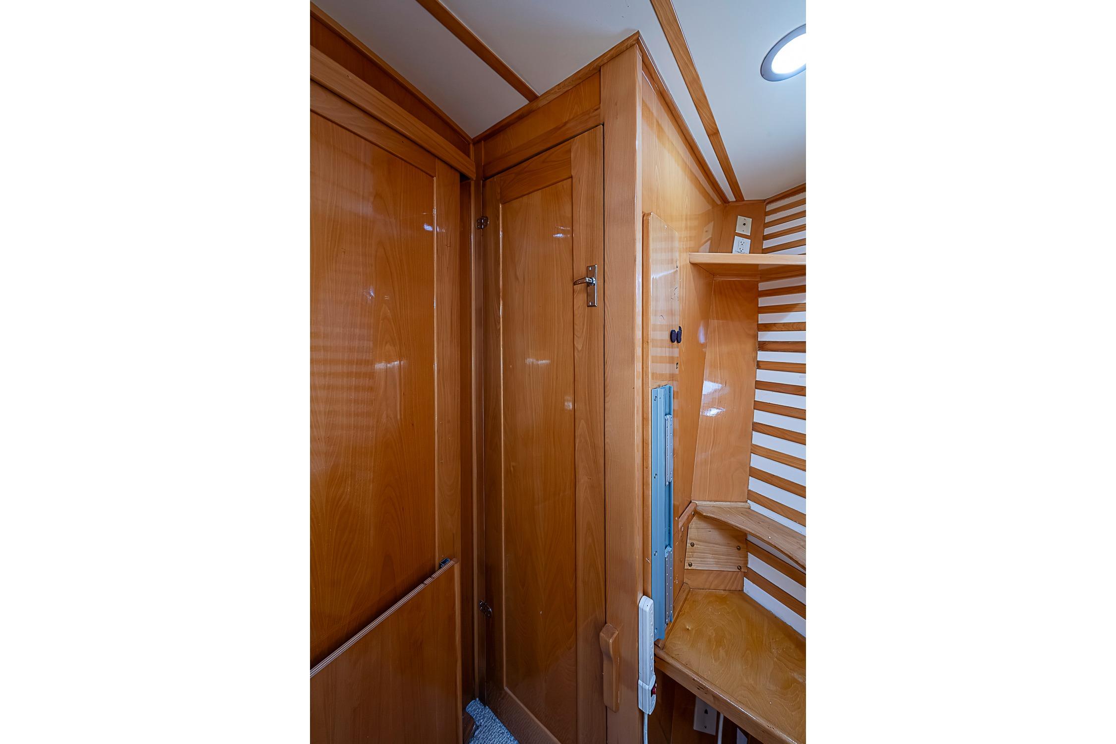 Wooden interior of 2003 Magna Marine Nova Scotia 47 boat, featuring cabinets and shelves.