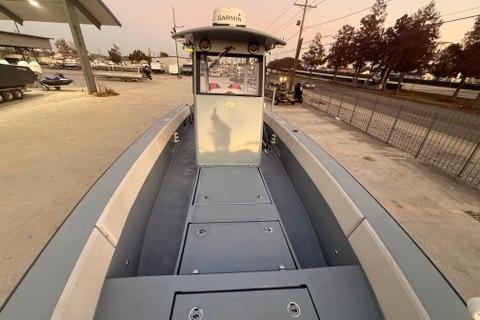 2019 Metal Shark 28 CC boat docked, showcasing spacious deck and control console.