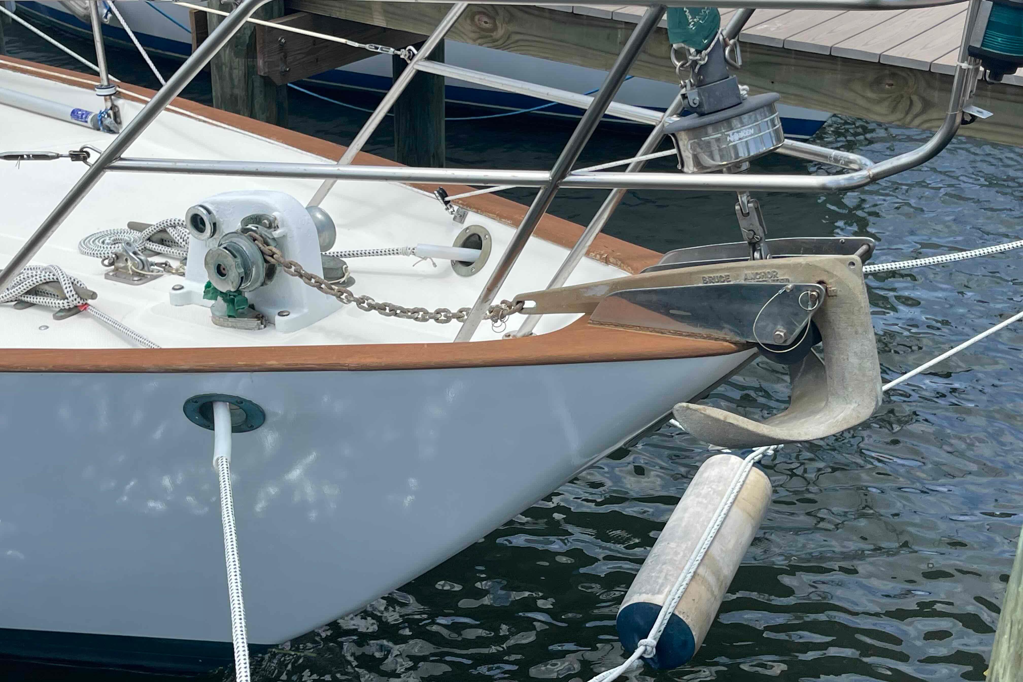 1987 Pacific Seacraft 34 sailboat bow with anchor and mooring lines at dock.