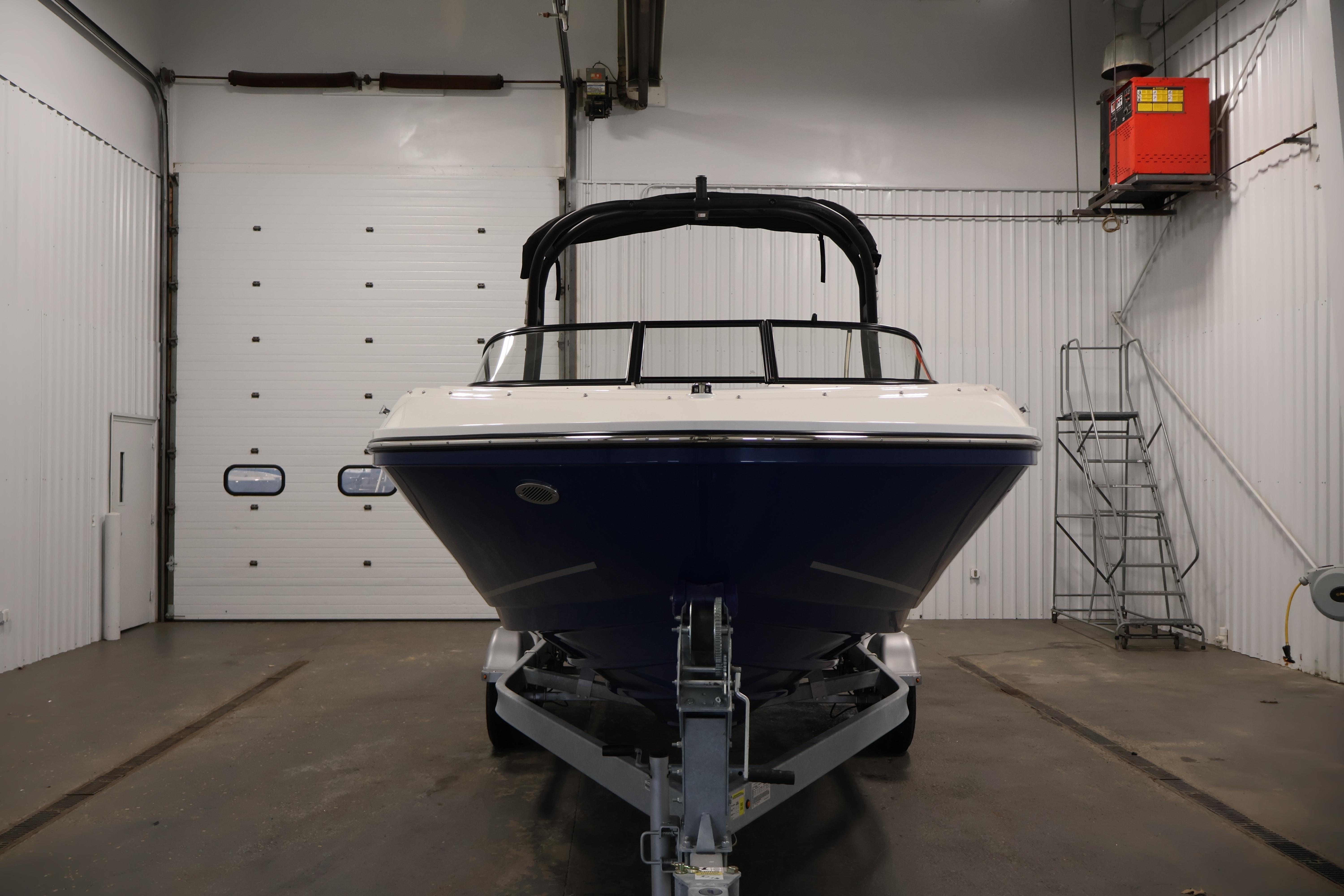 2026 Bayliner VR6 Bowrider I/O in indoor storage, front view.