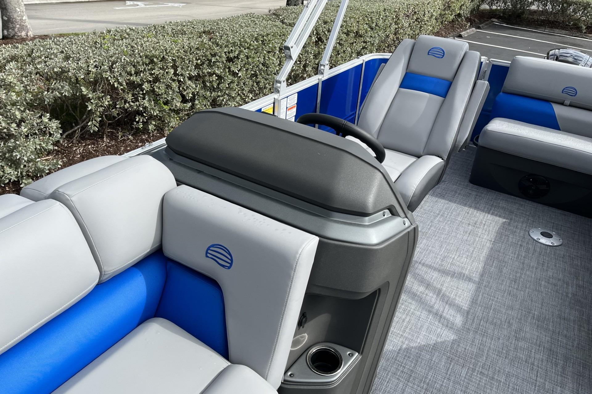 2026 Sun Tracker Party Barge 20 DLX interior with gray and blue seating.