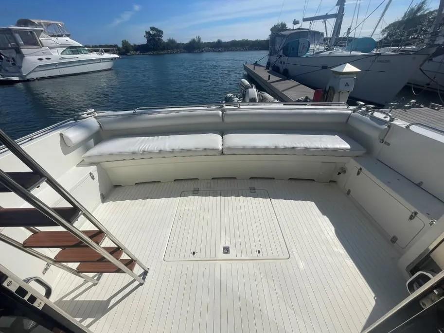1985 Princess Sedan Flybridge yacht deck with seating, docked at marina.