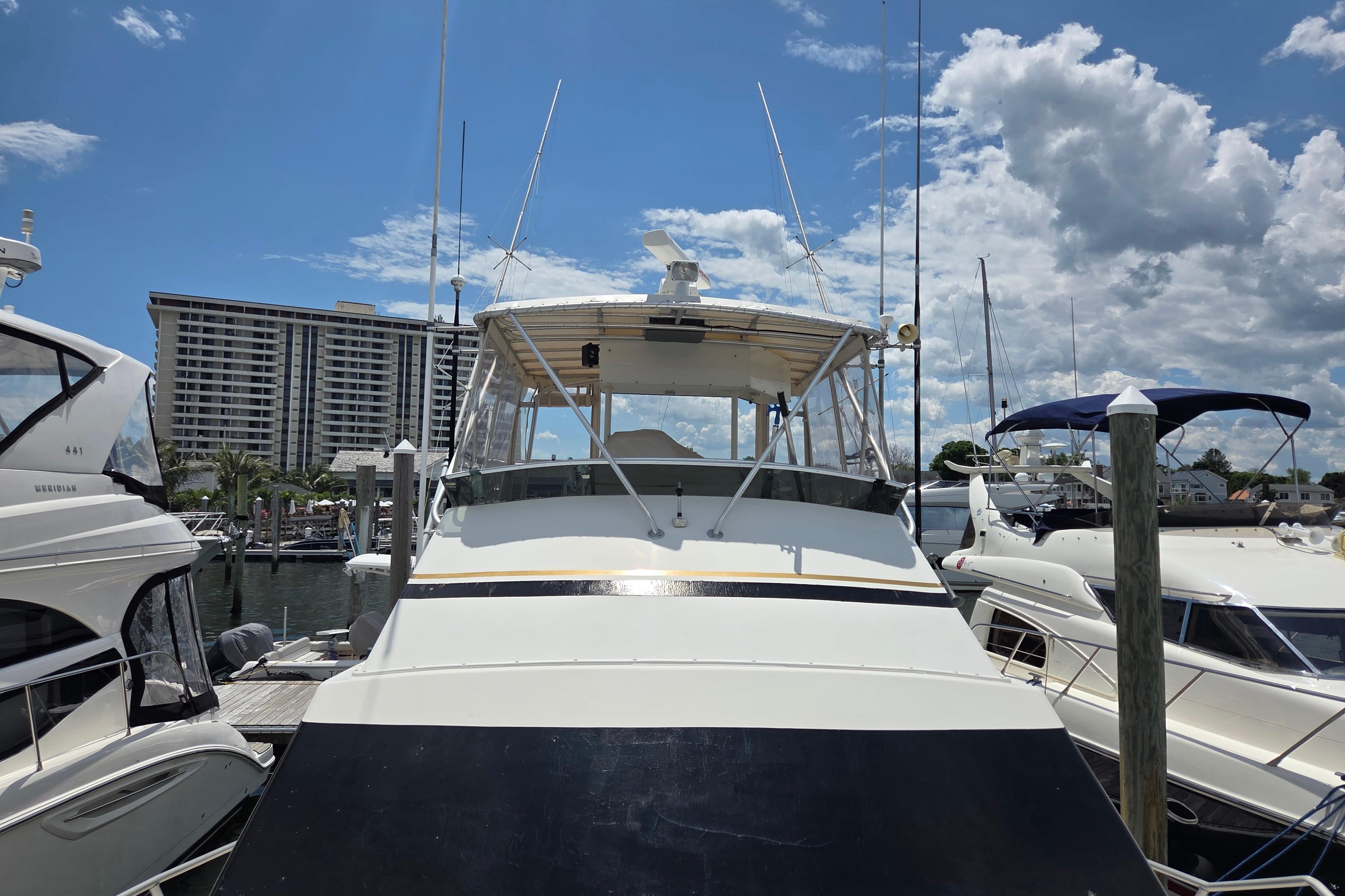 1990 Egg Harbor Golden Egg 42 yacht docked at marina under blue sky.