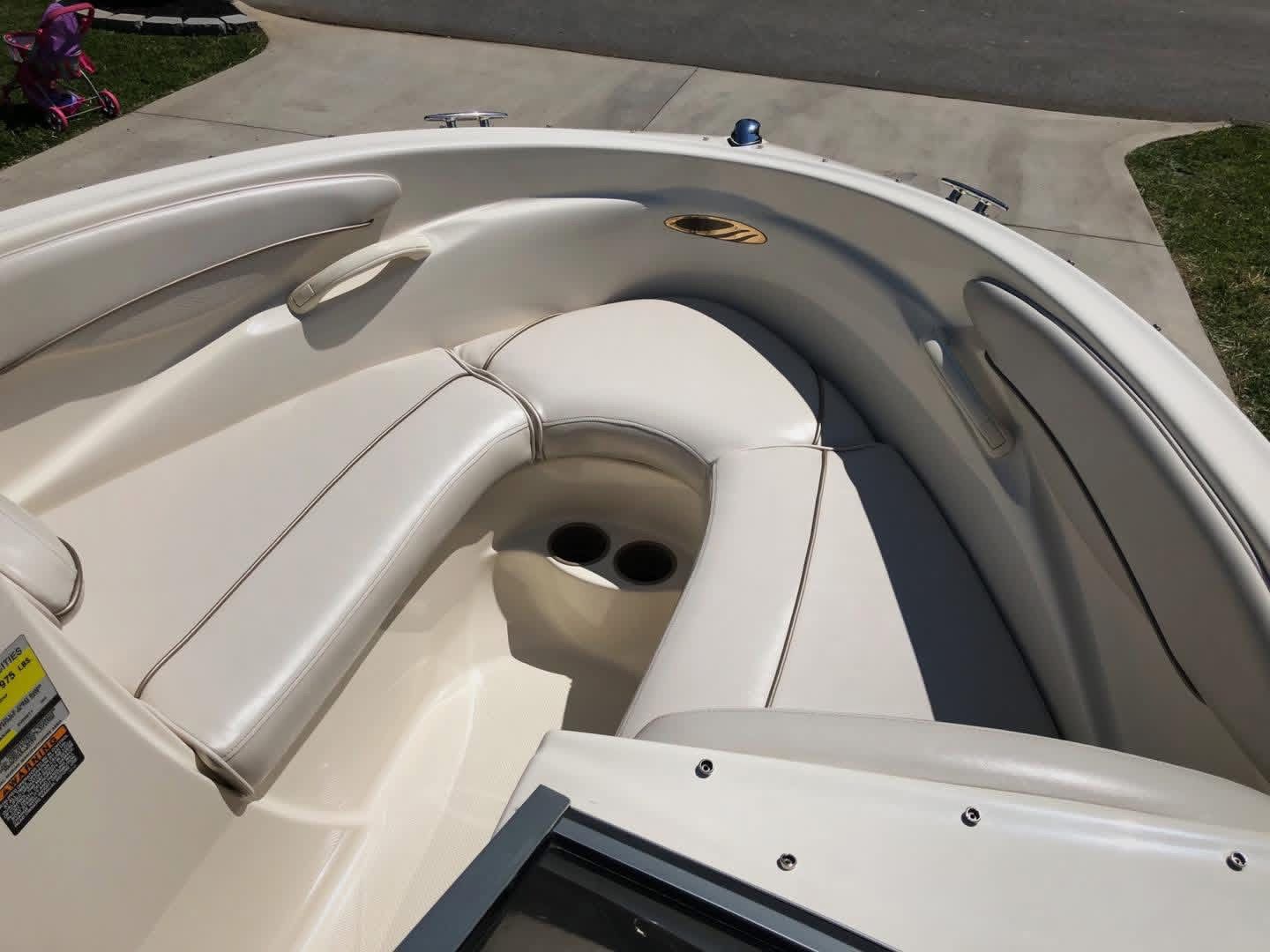 Interior of a 1999 Maxum 1800 SR boat with beige seating.