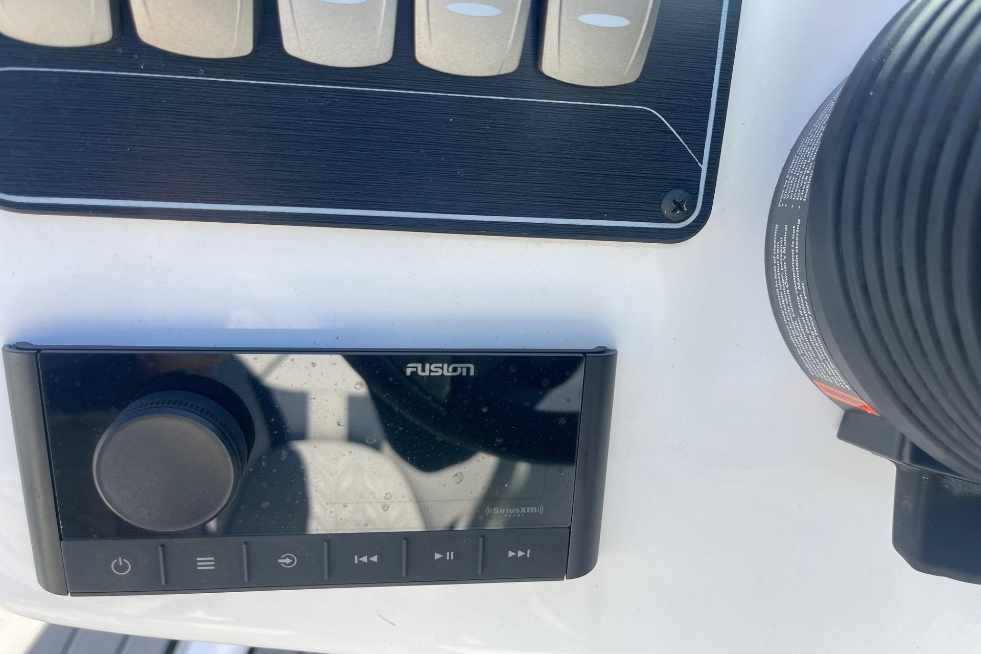 Fusion audio system on 2023 Hurricane SunDeck 2400 OB boat dashboard.