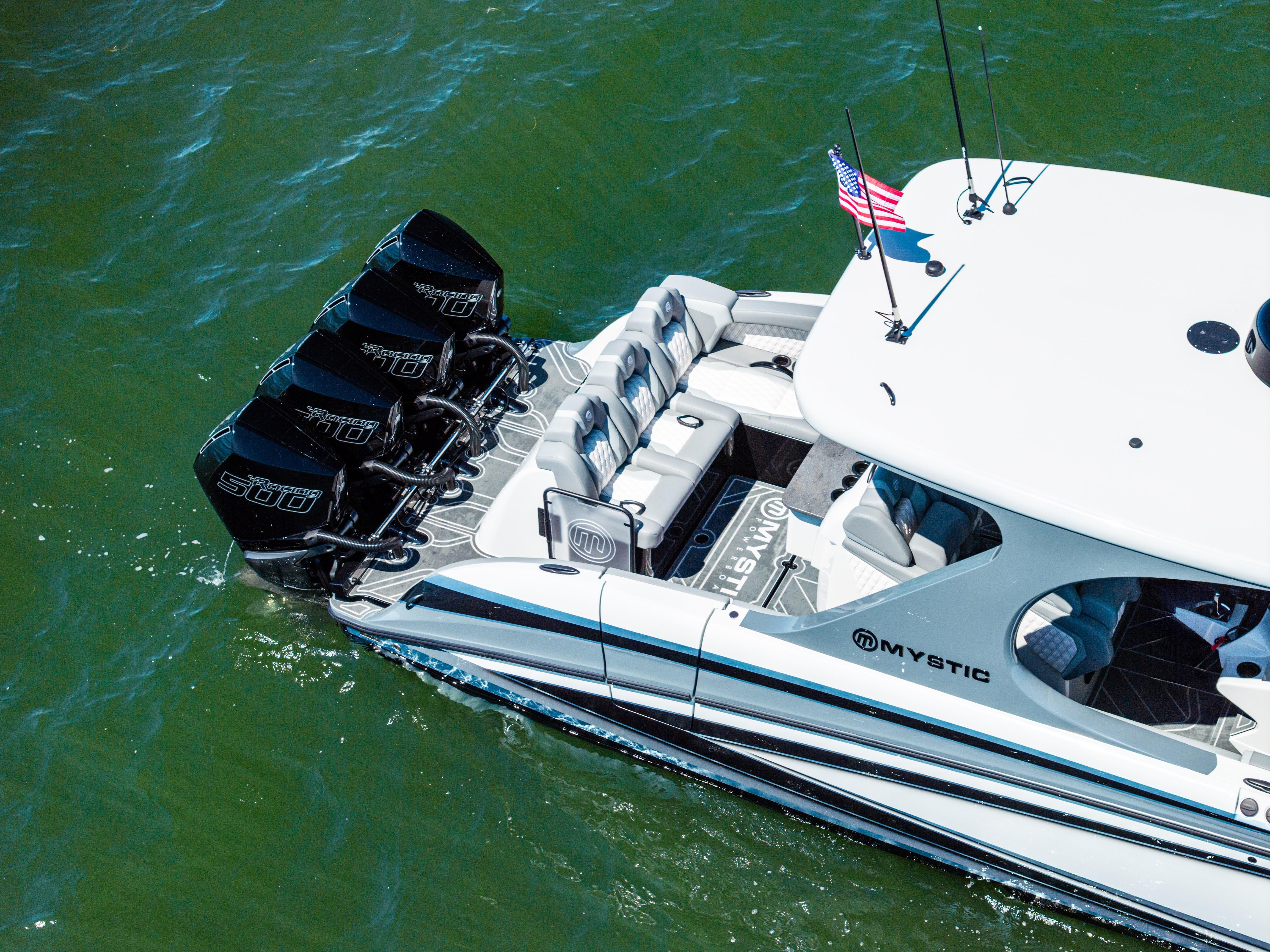 2026 Mystic Powerboats M4200 with quad engines cruising on water.