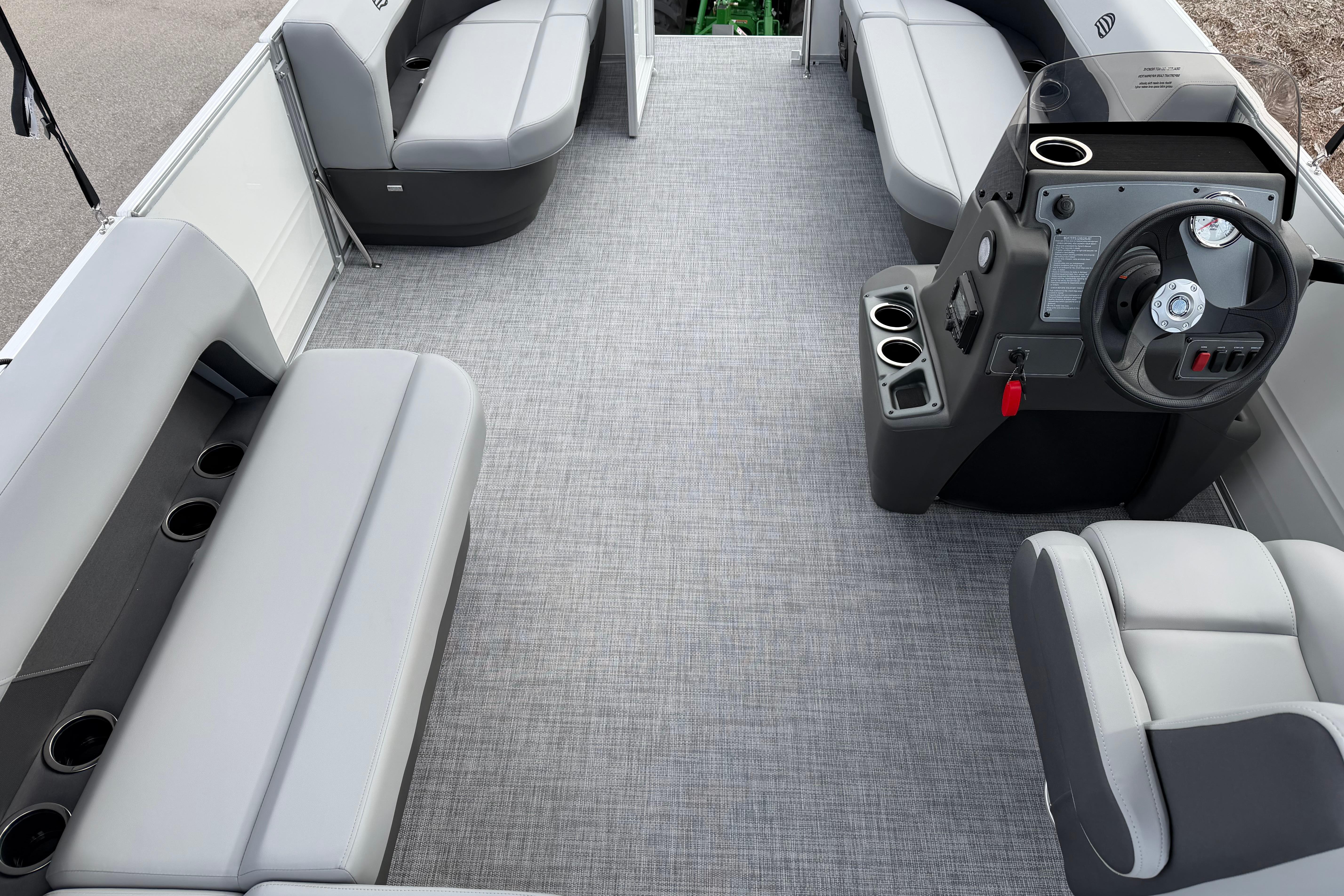 Interior of 2026 Sun Tracker Party Barge 16 DLX with gray seating and steering console.