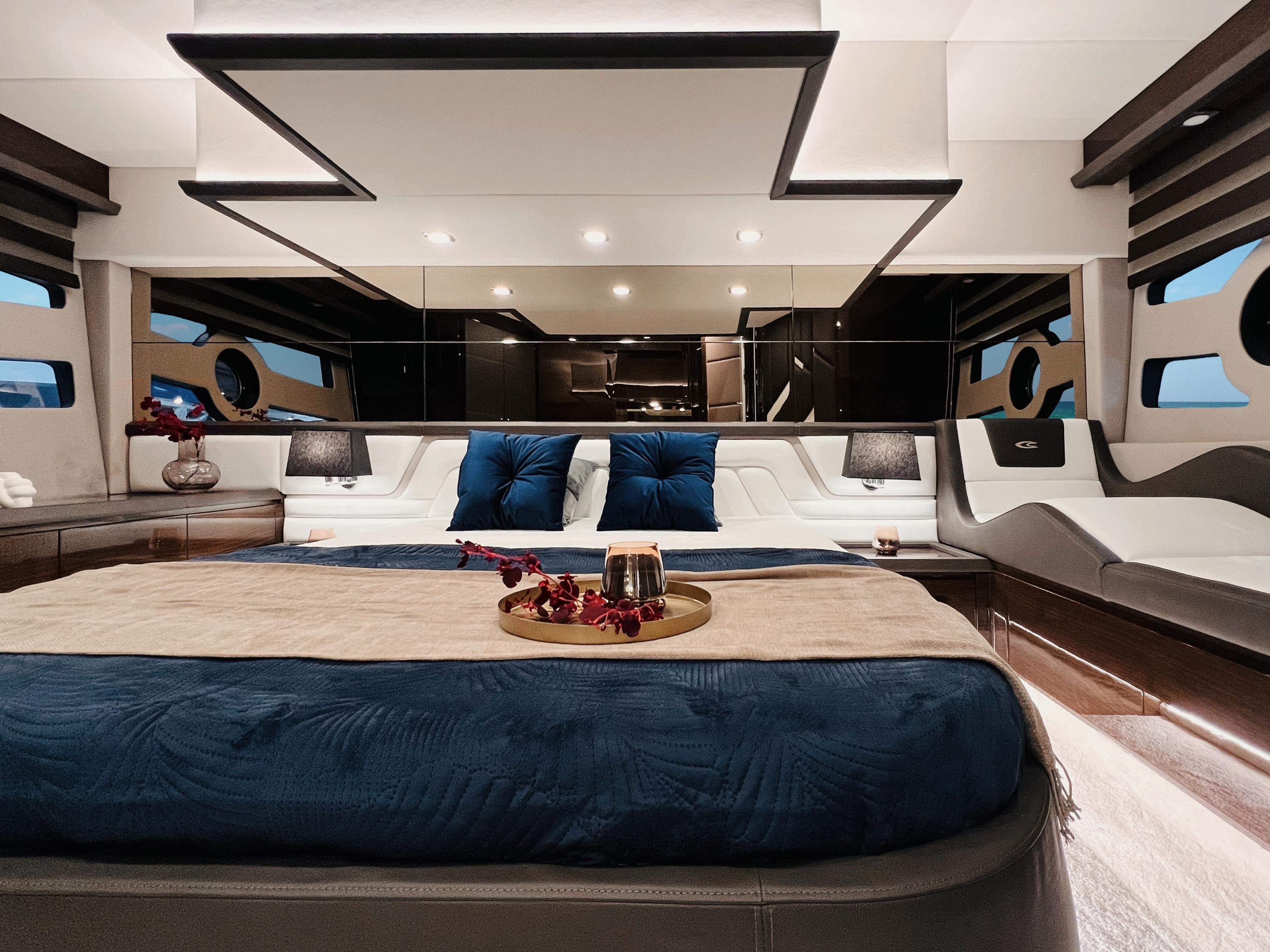 Luxurious interior of 2025 Cobrey 52 FLY yacht with elegant bedding and modern design.