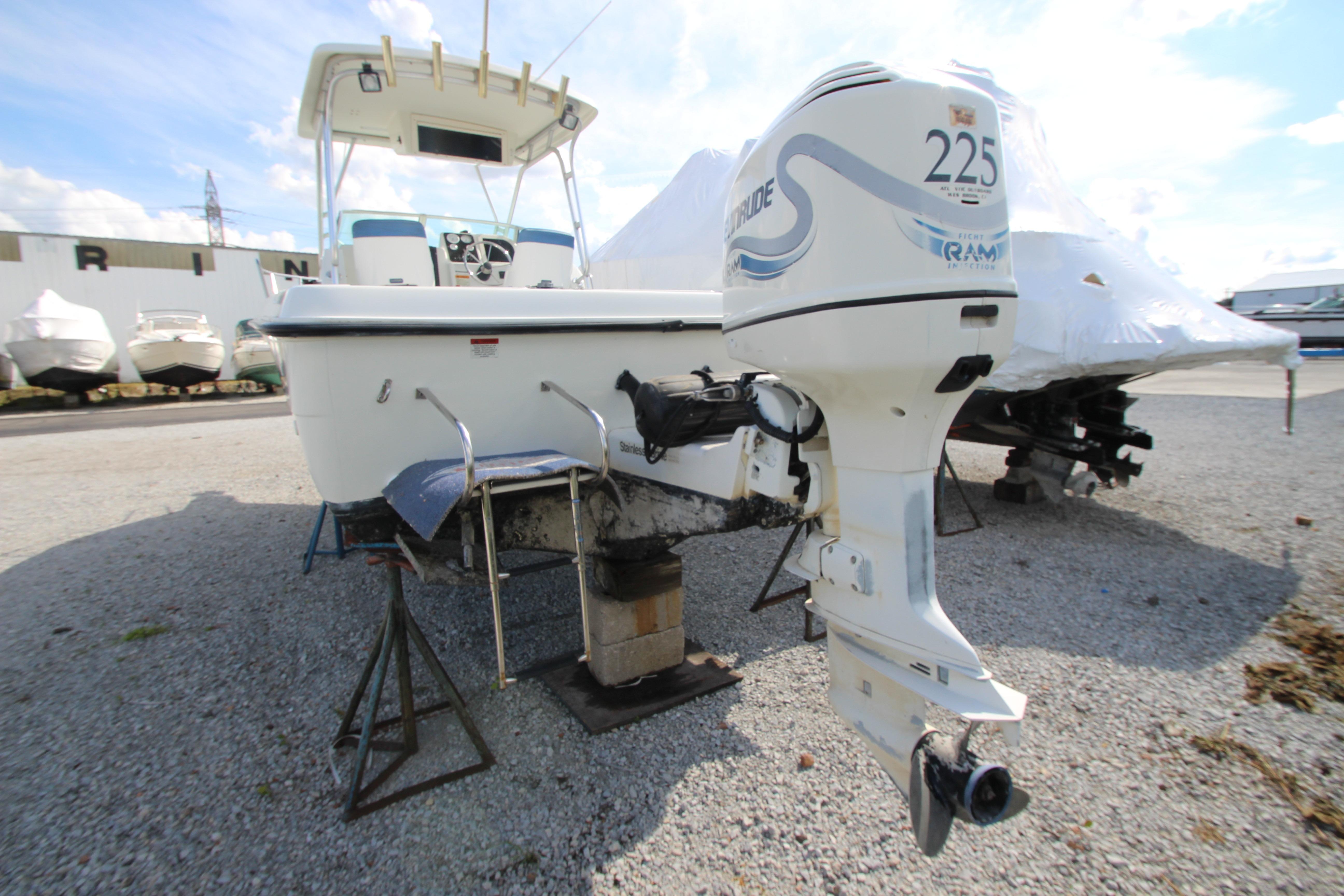 2002 Hydra-Sports 230 WA boat with outboard motor on display in a marina.