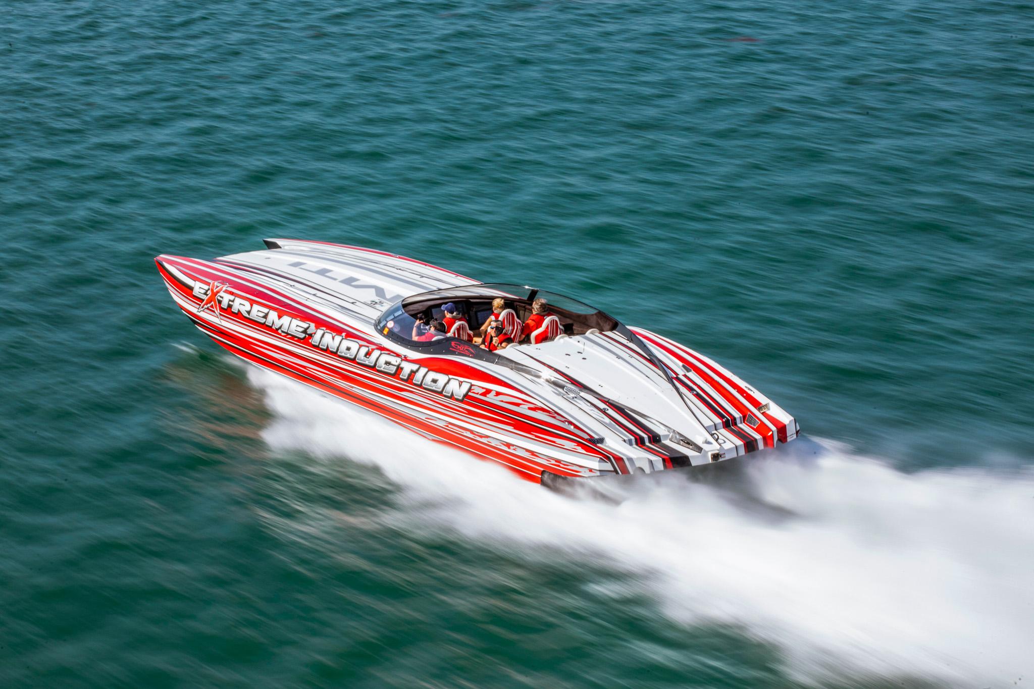 High-speed MTI 48 powerboat racing on water, featuring bold red and white design.