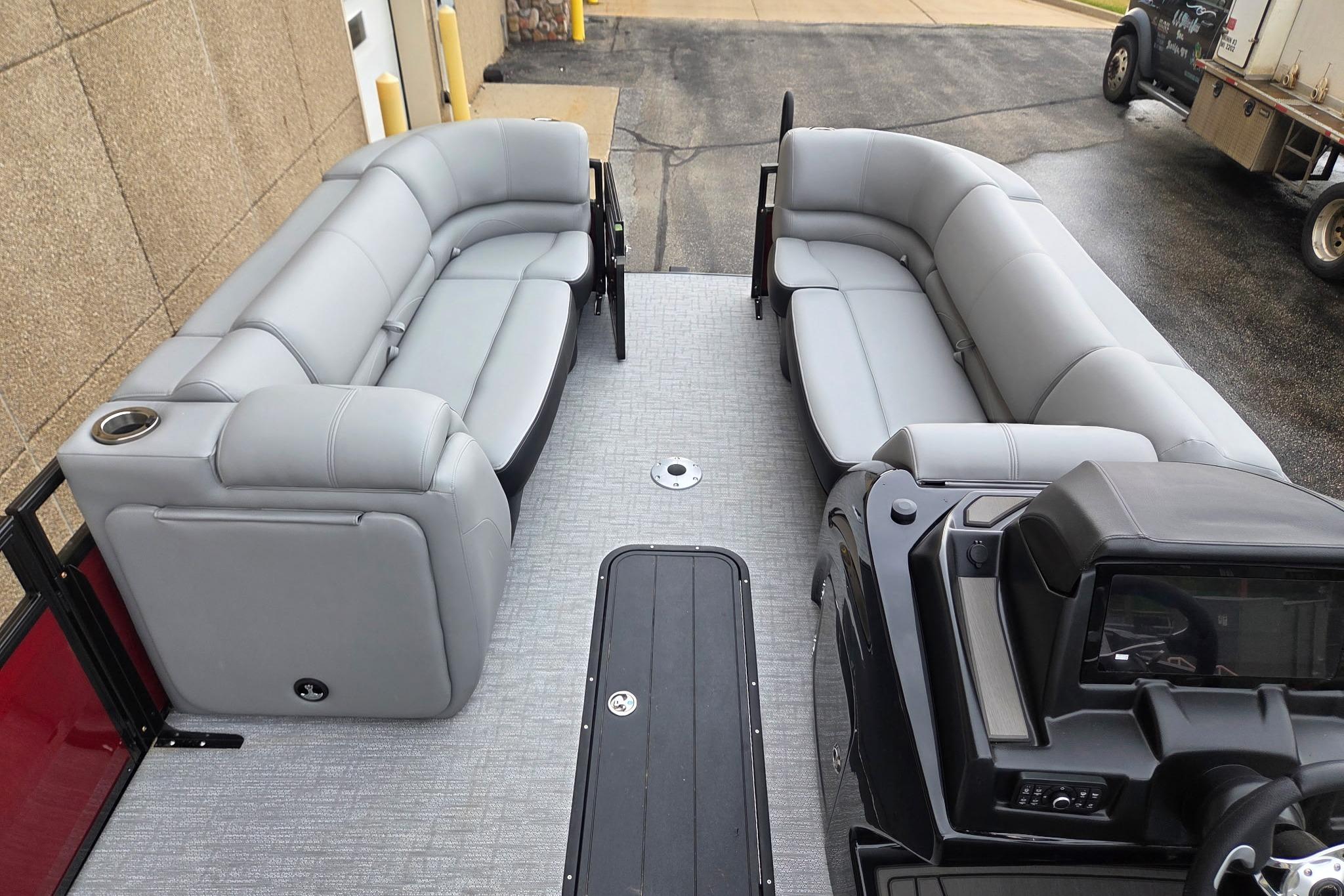 2026 Regency 230 DL pontoon boat with spacious gray seating and modern console.