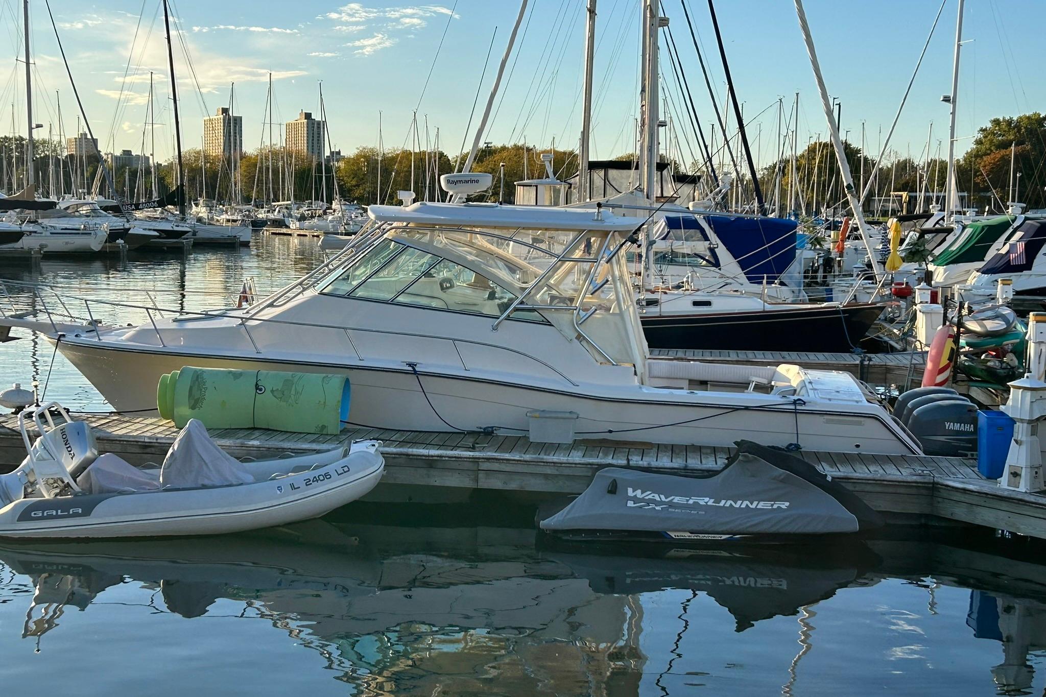 2007 Grady-White Express 360 boat docked in a marina with other vessels.