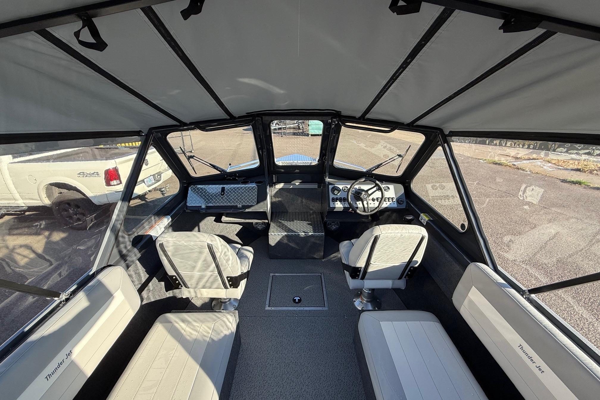 Interior view of 2026 Thunder Jet 200 Luxor boat with seating and steering console.