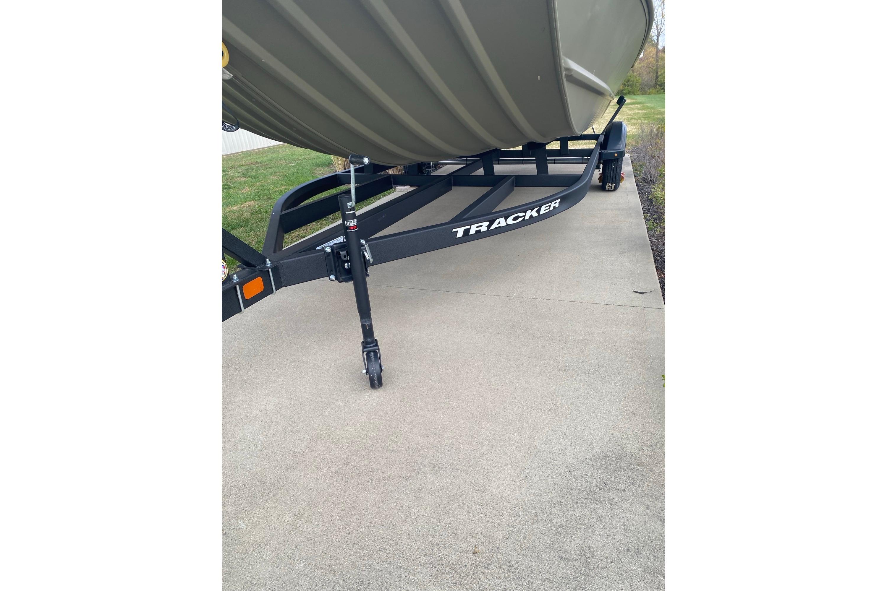 2026 Tracker Grizzly 2072 Utility boat on trailer, parked on concrete driveway.