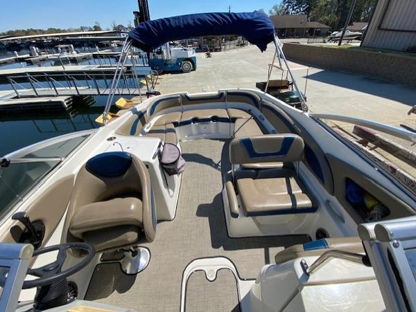 2005 Bayliner 249 SD boat interior with seating and steering wheel at marina.
