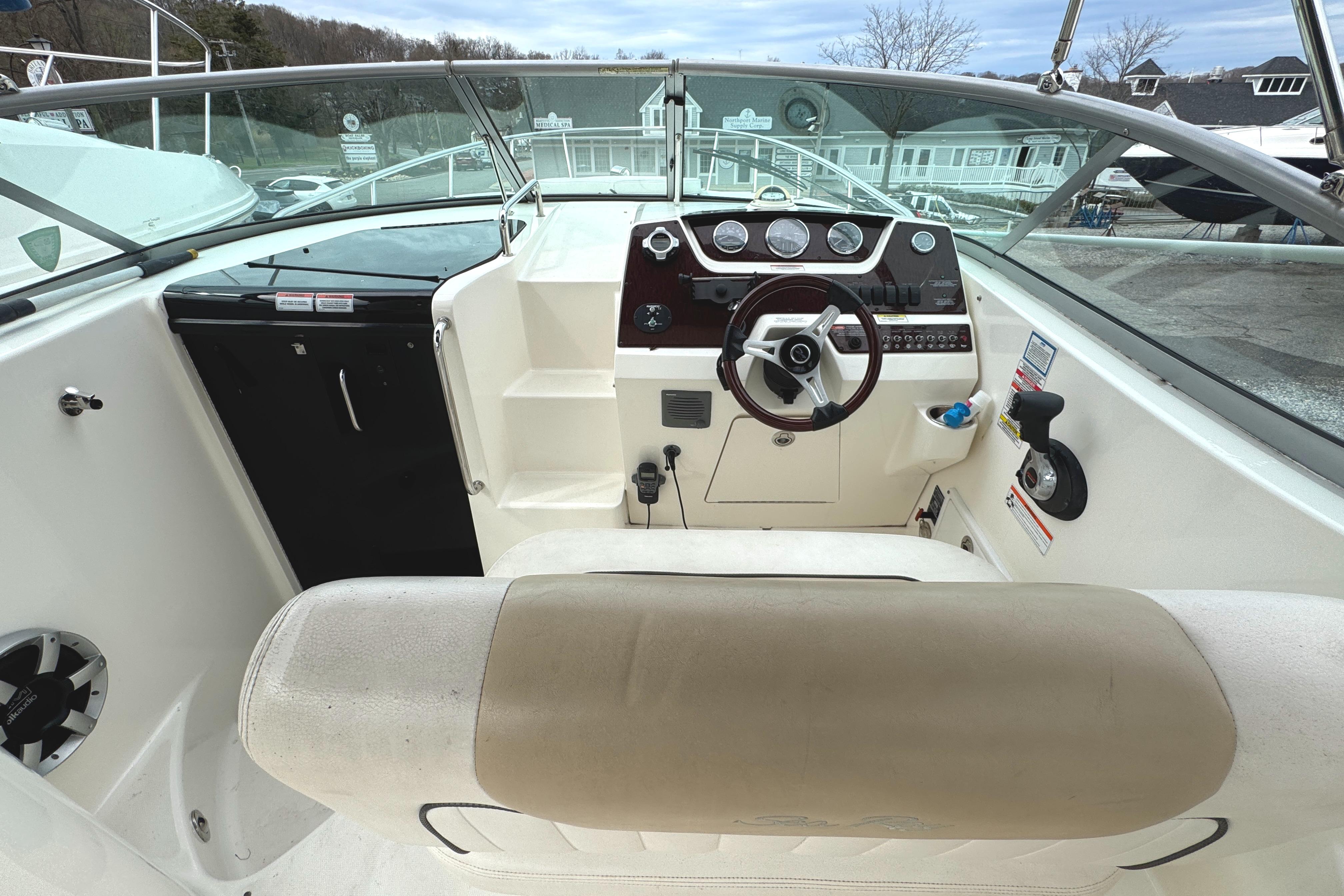 2010 Sea Ray 280 Sundancer cockpit with steering wheel and dashboard controls.