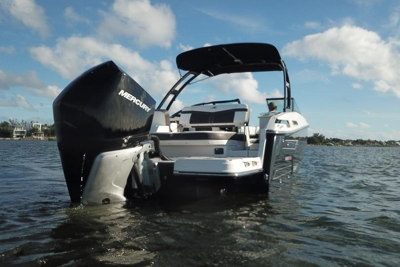 2022 Monterey 255SS Super Sport boat on water, rear view with Mercury engine.