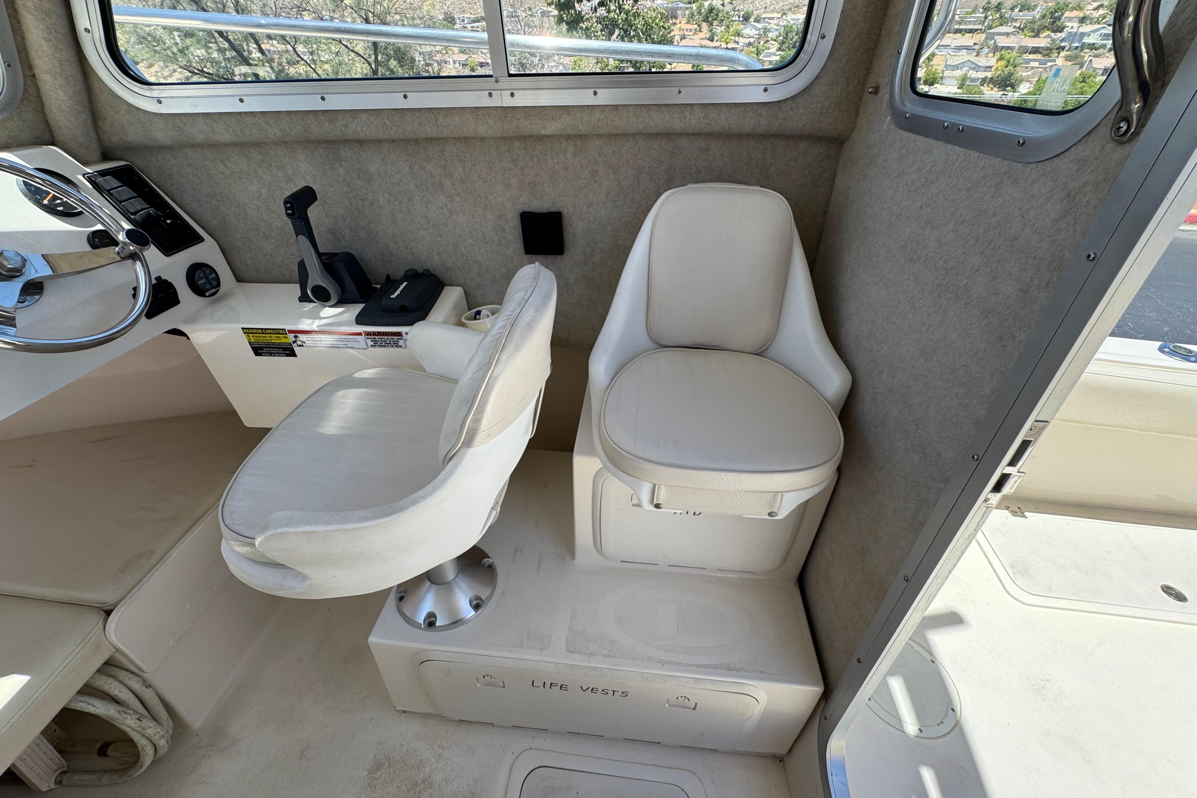 Interior of a 2017 Defiance Admiral 220 EX boat with two white seats.