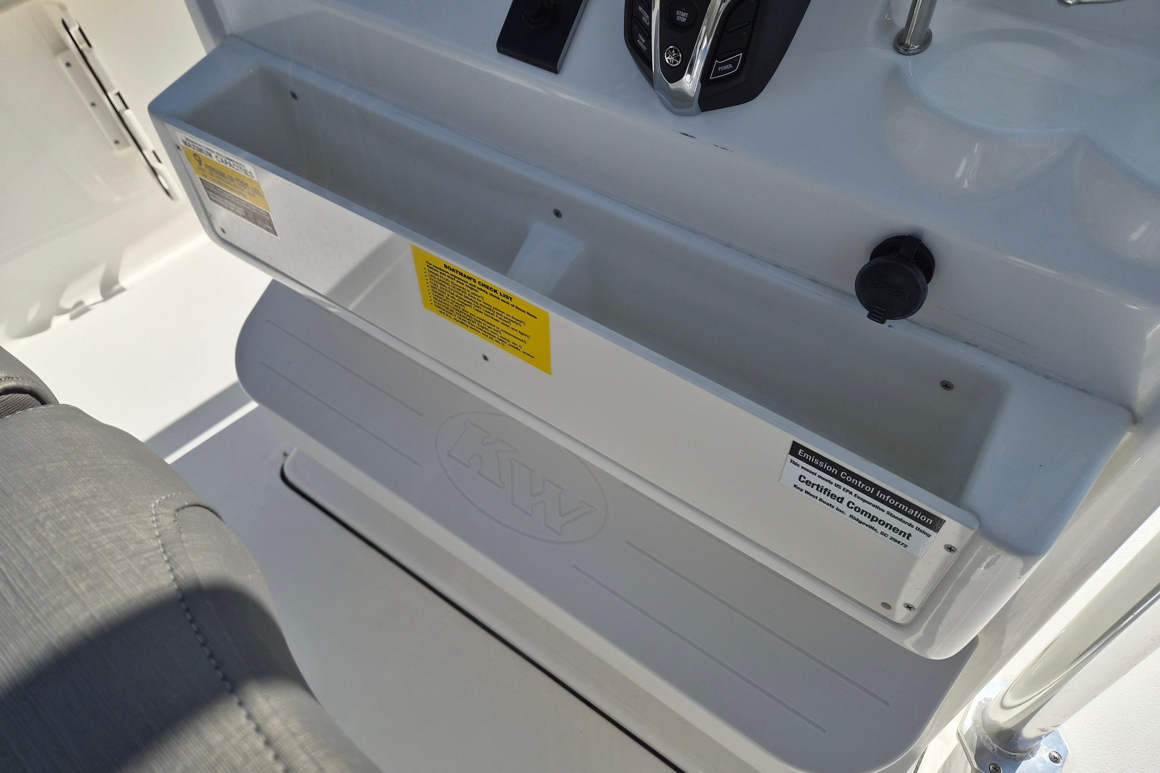 2026 Key West 239 FS boat console with storage compartment and control panel.