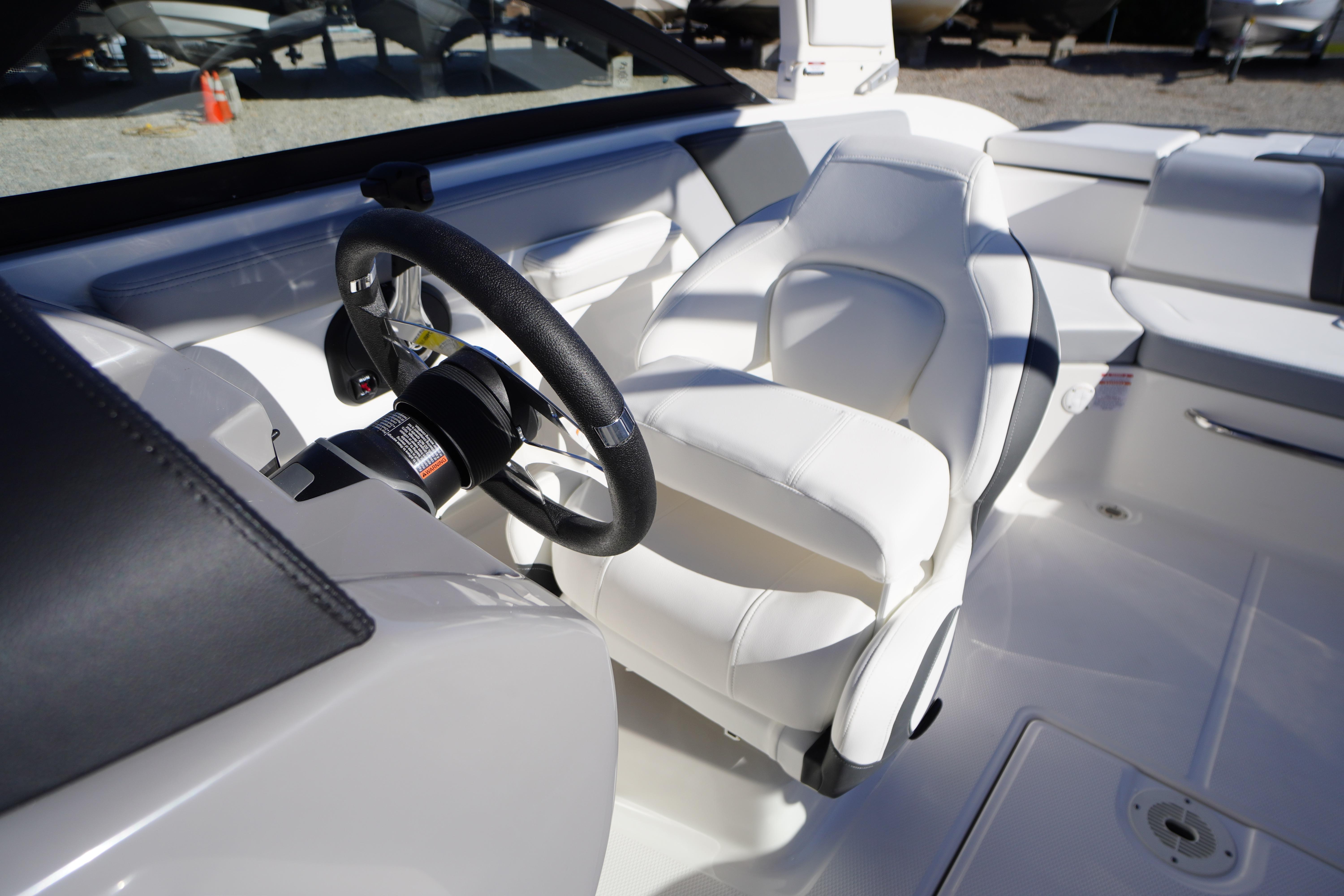 2026 Chaparral 23 SSi boat interior with white seating and steering wheel.