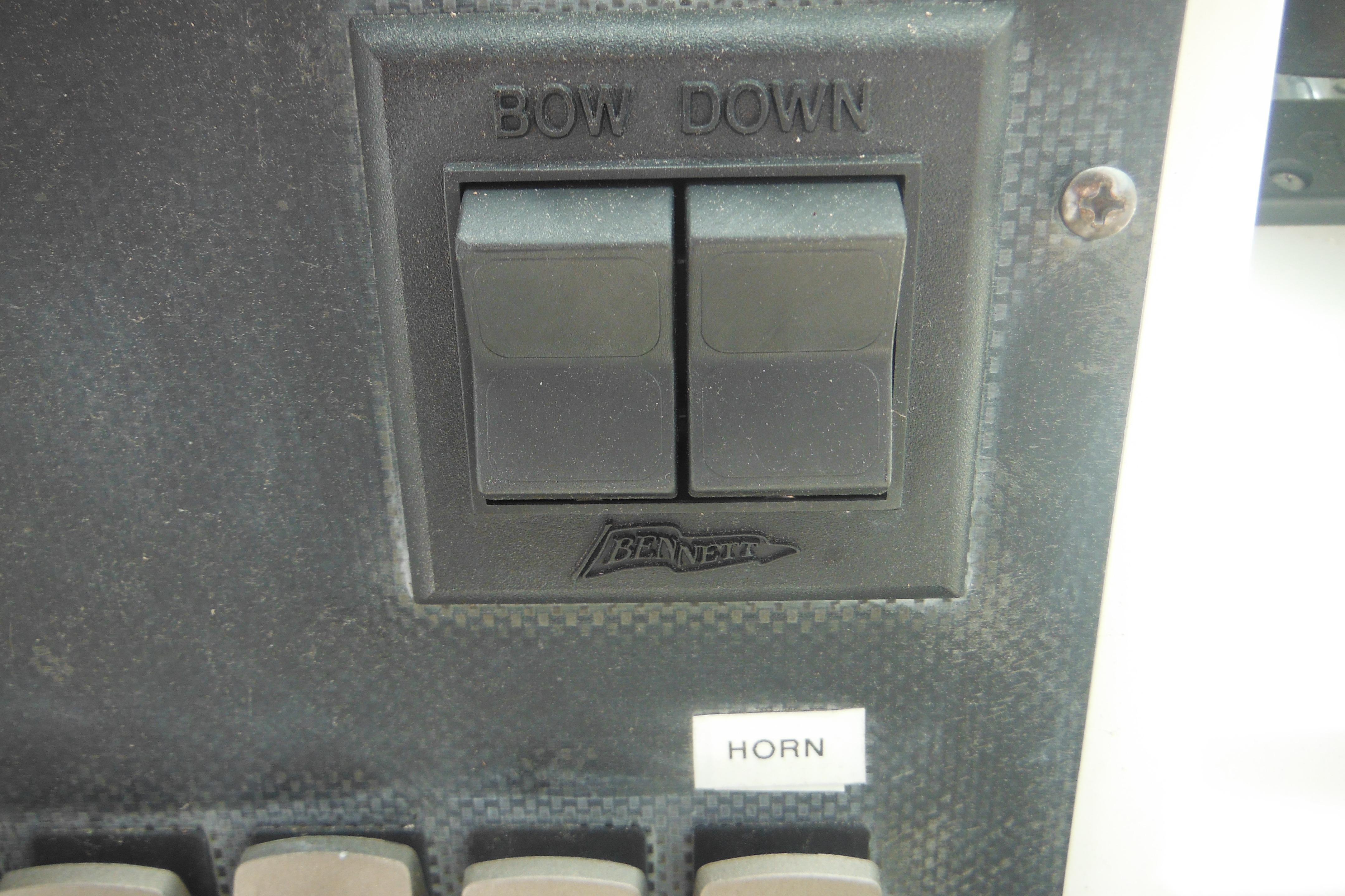 Control panel of a 2005 Seaswirl Striper 2101 Walkaround O/B with bow down and horn switches.
