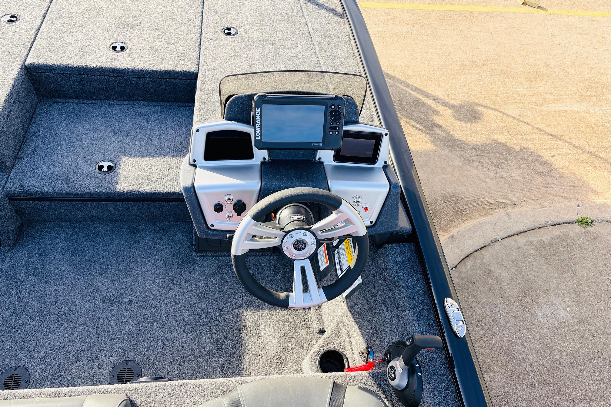 2025 Tracker Savage 215 boat dashboard with steering wheel and navigation system.