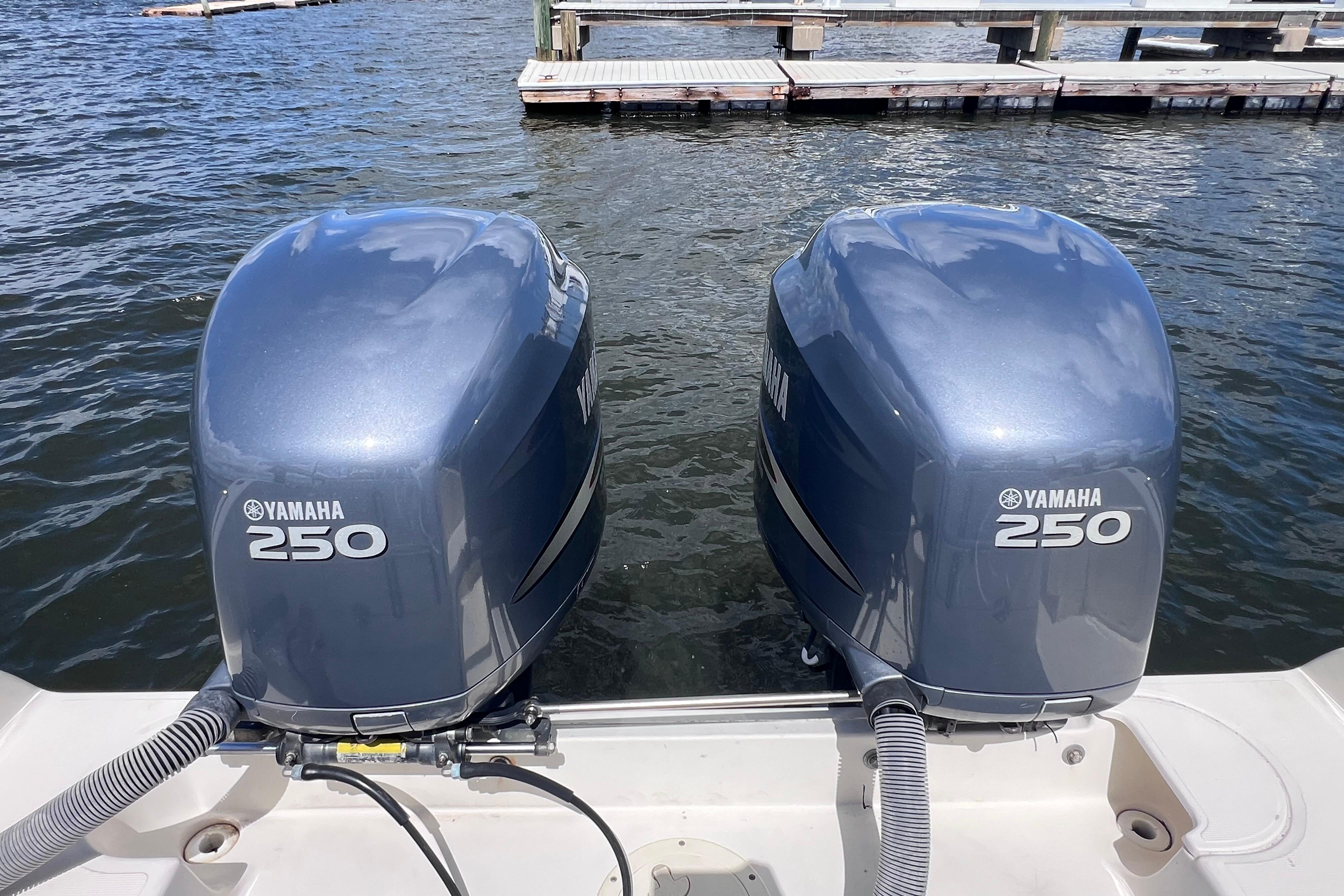 Twin Yamaha 250 outboard motors on a 2004 Pursuit 2870 Walkaround boat at dock.