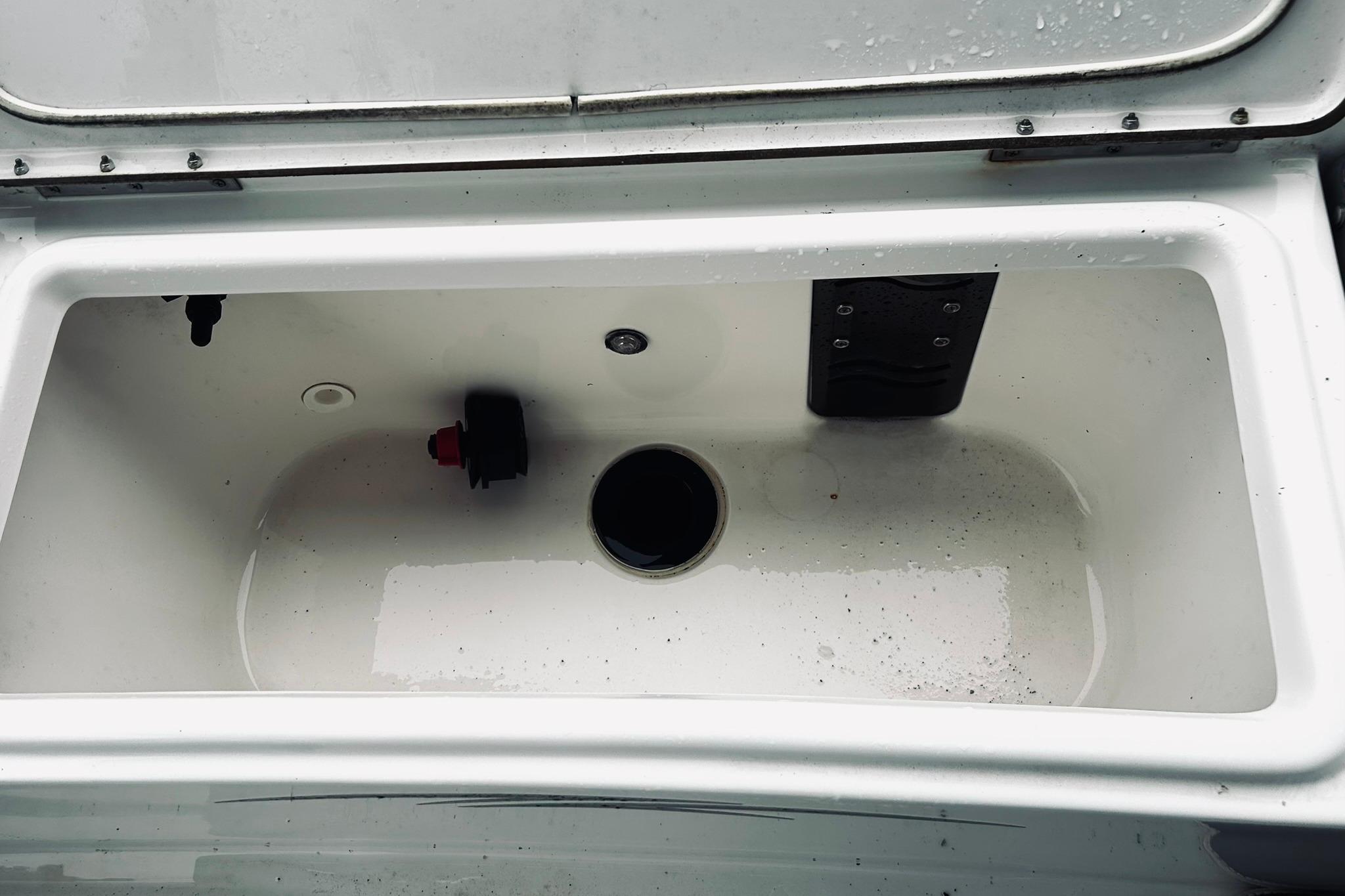 Open storage compartment of 2017 Blue Wave 2200 PureBay boat, showing interior details.