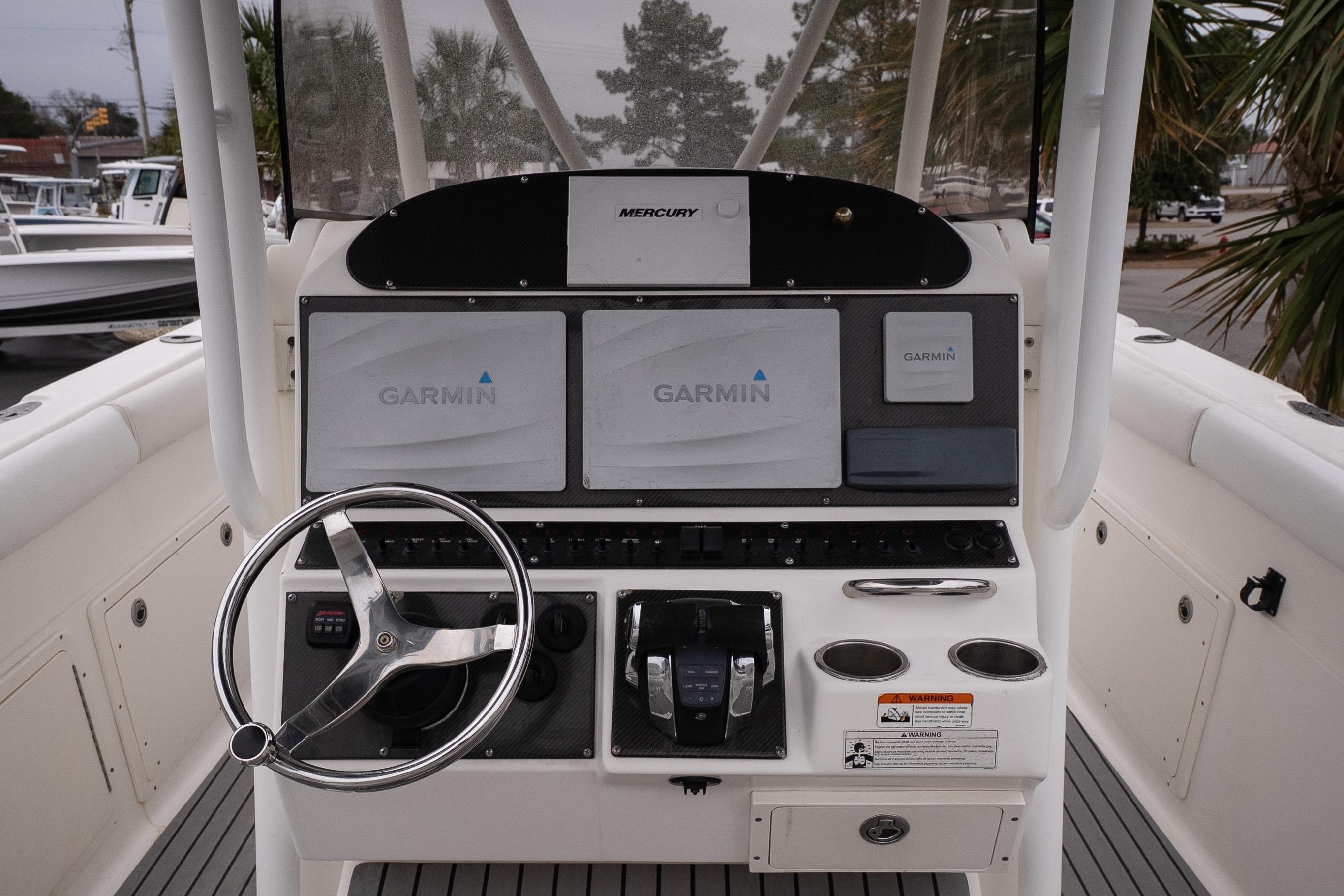 2007 Wellcraft 35 Tournament boat helm with Garmin navigation displays and steering wheel.