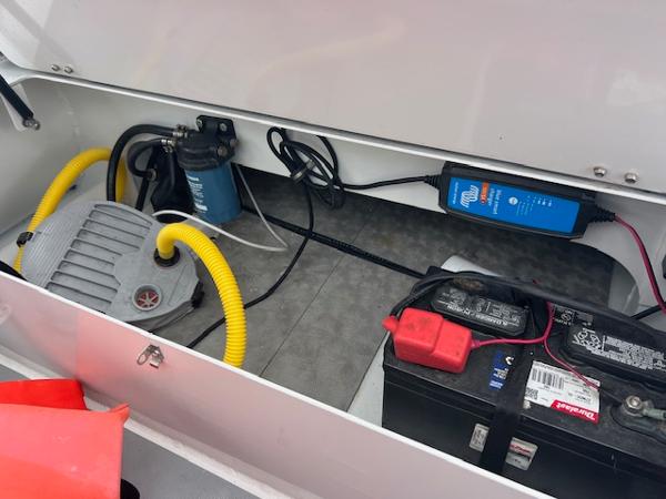 2017 Highfield OM 500 boat storage compartment with battery and pump system.