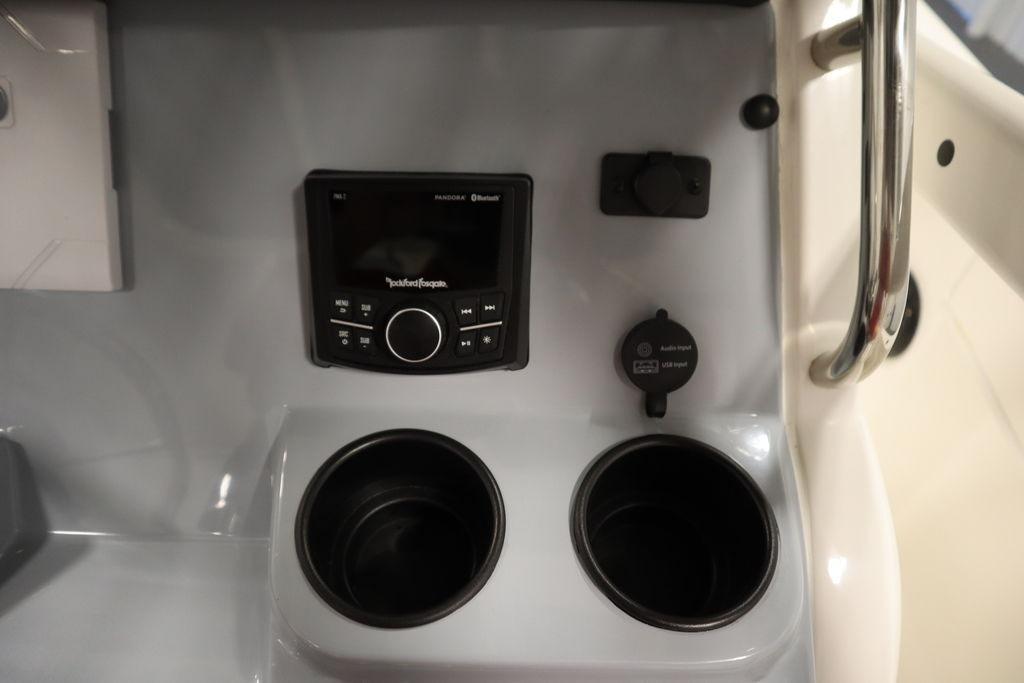 Control panel of 2026 Bayliner Trophy T20CC with audio system and cup holders.