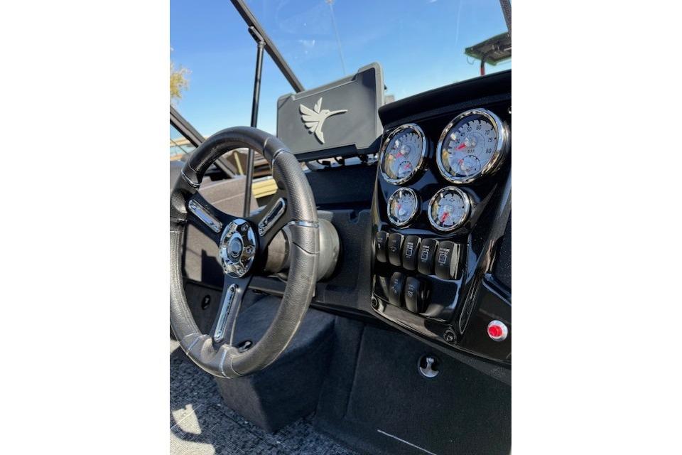 2026 Tracker Targa V-19 WT dashboard with steering wheel and instrument panel.