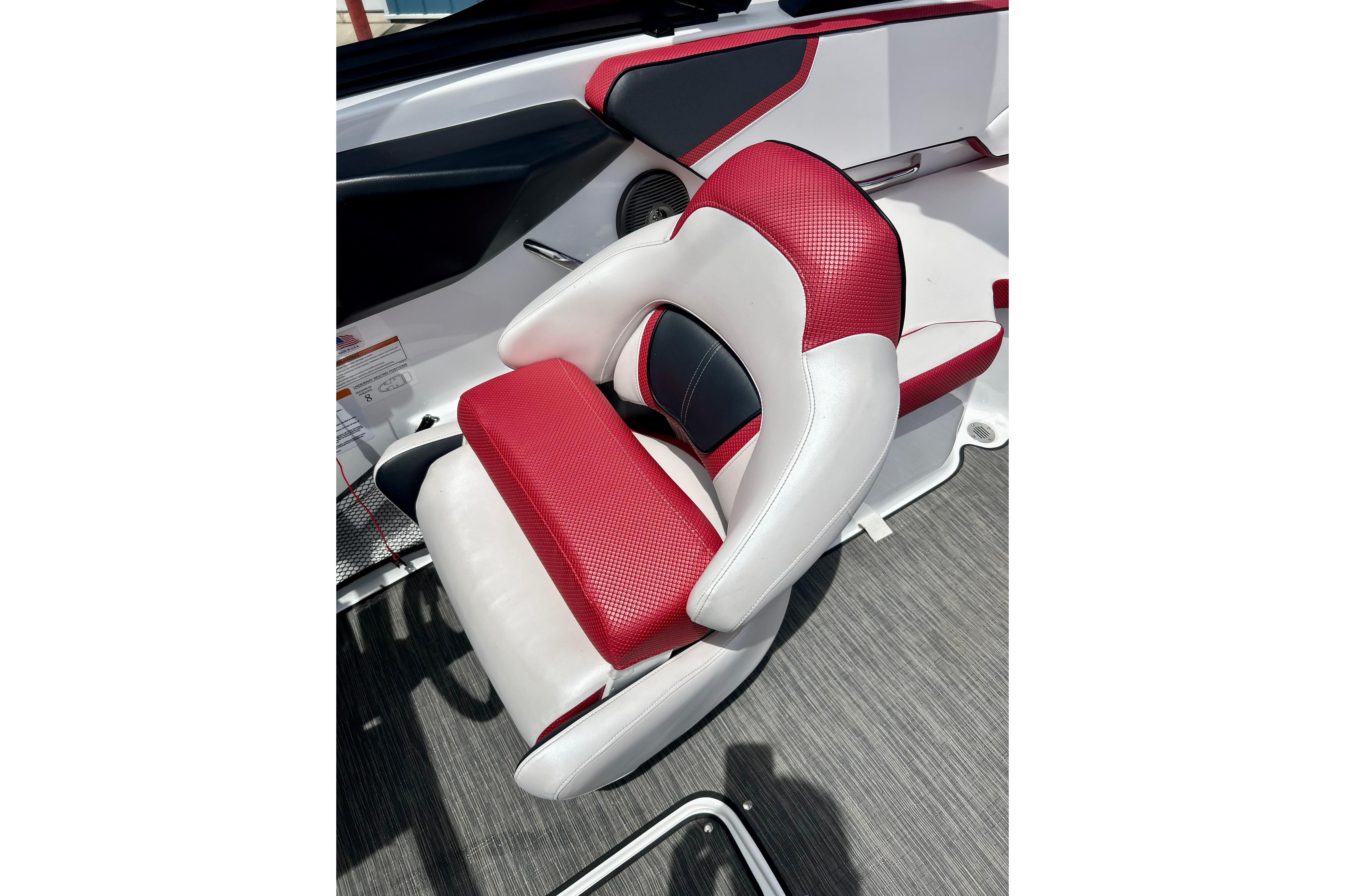 Red and white seat in 2021 Scarab 195 ID boat interior.