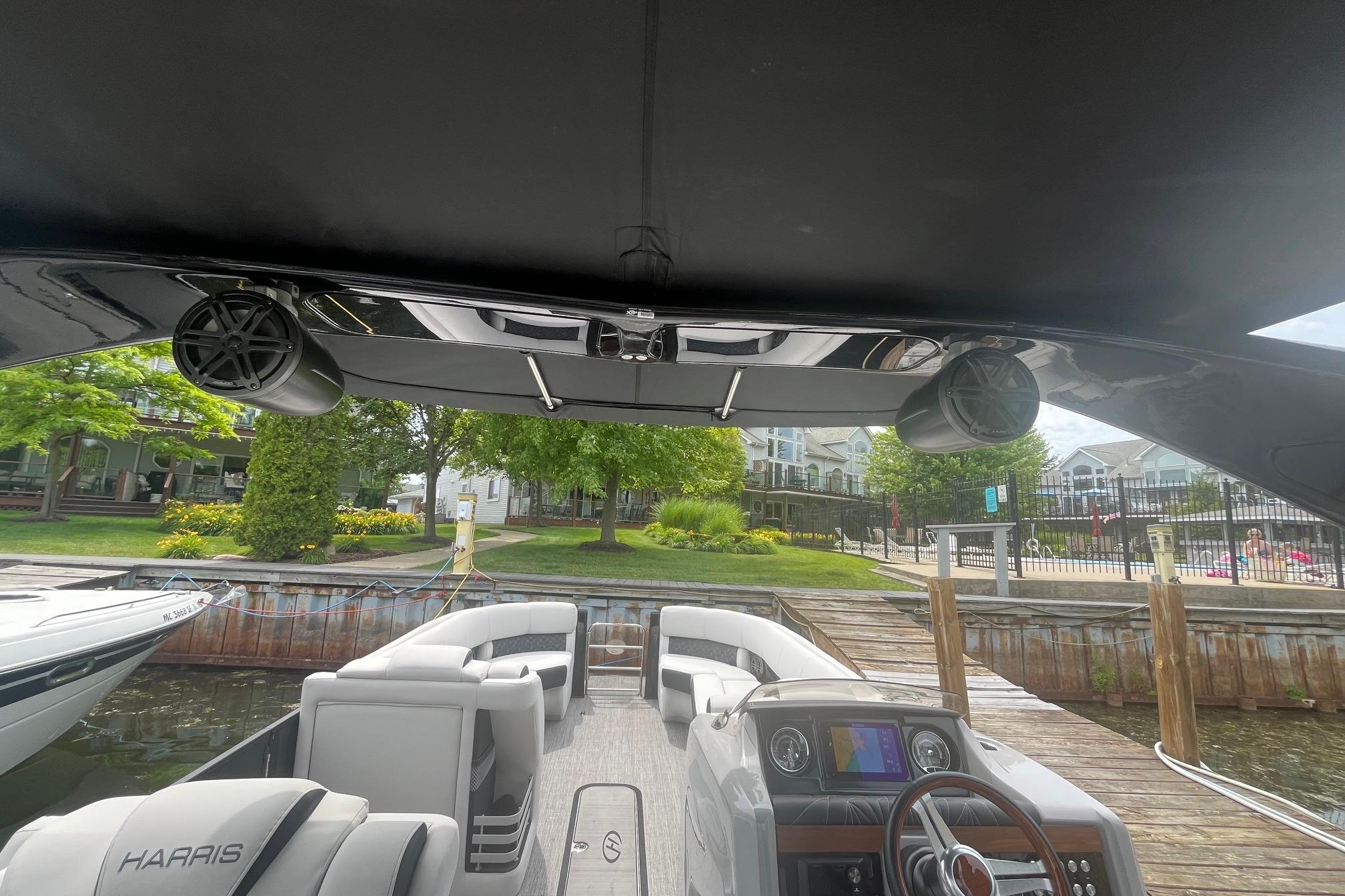 2024 Harris Grand Mariner 250 boat interior with modern dashboard and waterfront view.