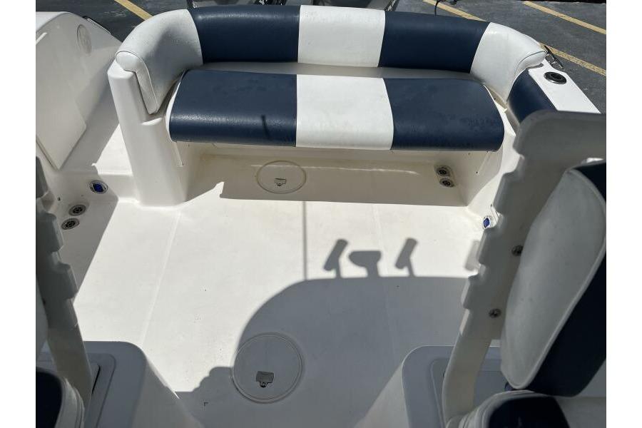 2006 Century 2400 Walk-Around boat interior with blue and white seating.
