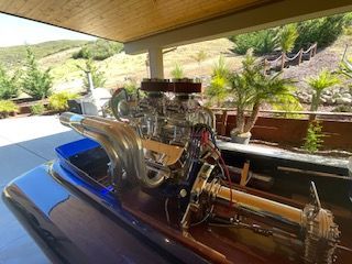 A 1980 Sanger HYDRO V DRIVE with a powerful engine, surrounded by scenic landscape.