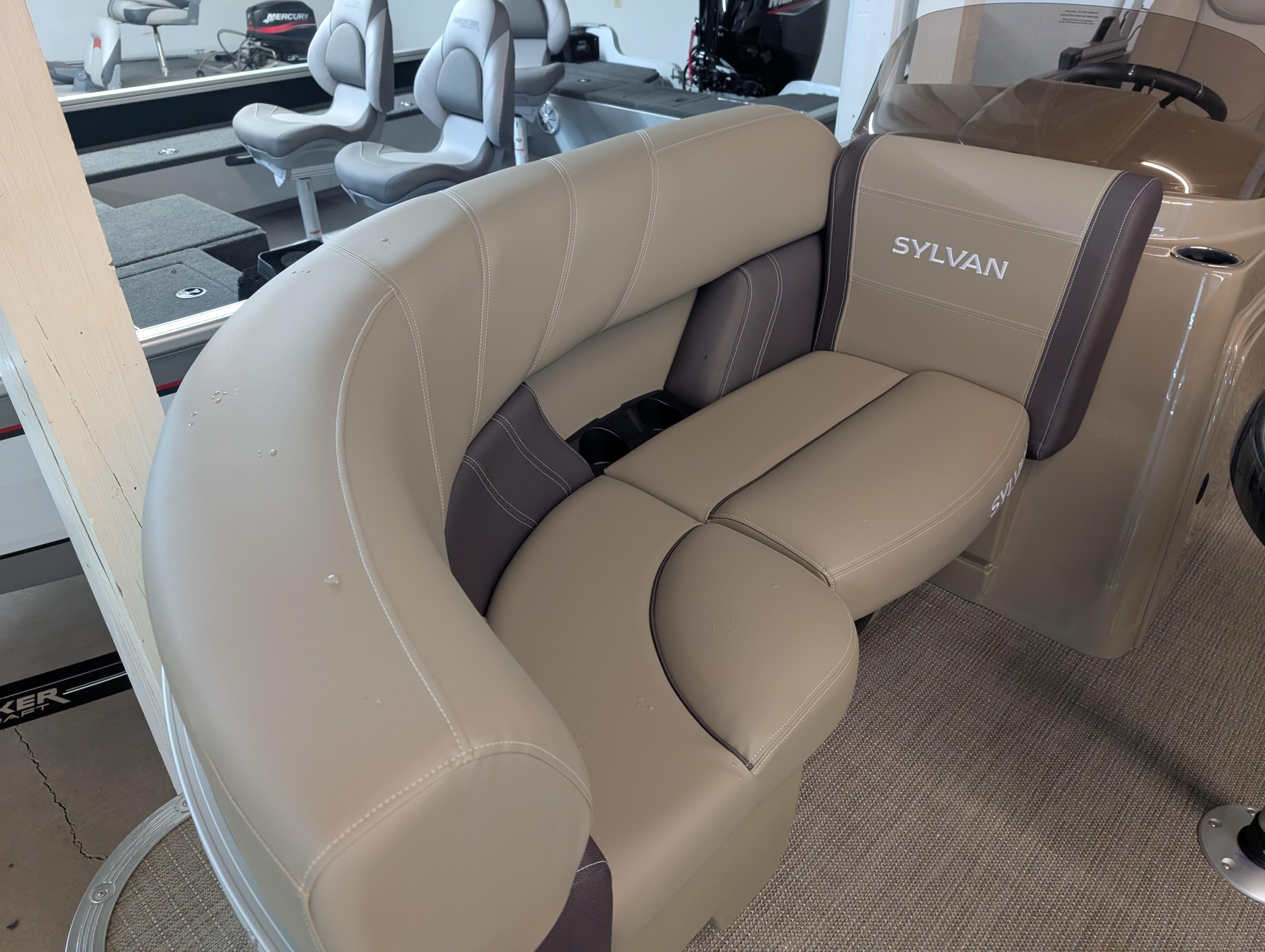 Luxurious seating in 2025 Sylvan Mirage Cruise 8520 CLZ DH pontoon boat, featuring beige upholstery.