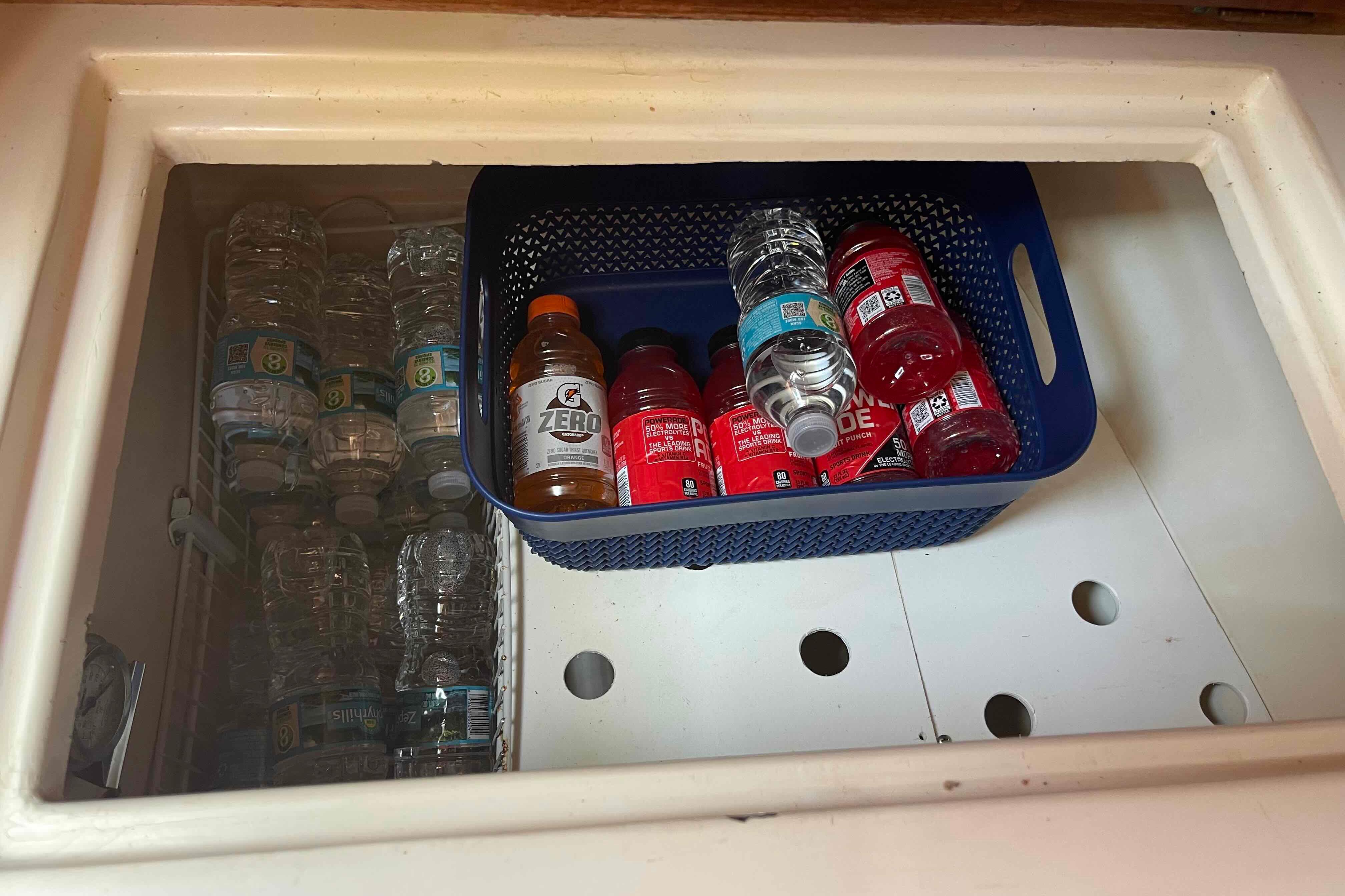 Storage compartment on a 1987 Pacific Seacraft 34, holding bottled drinks and water.