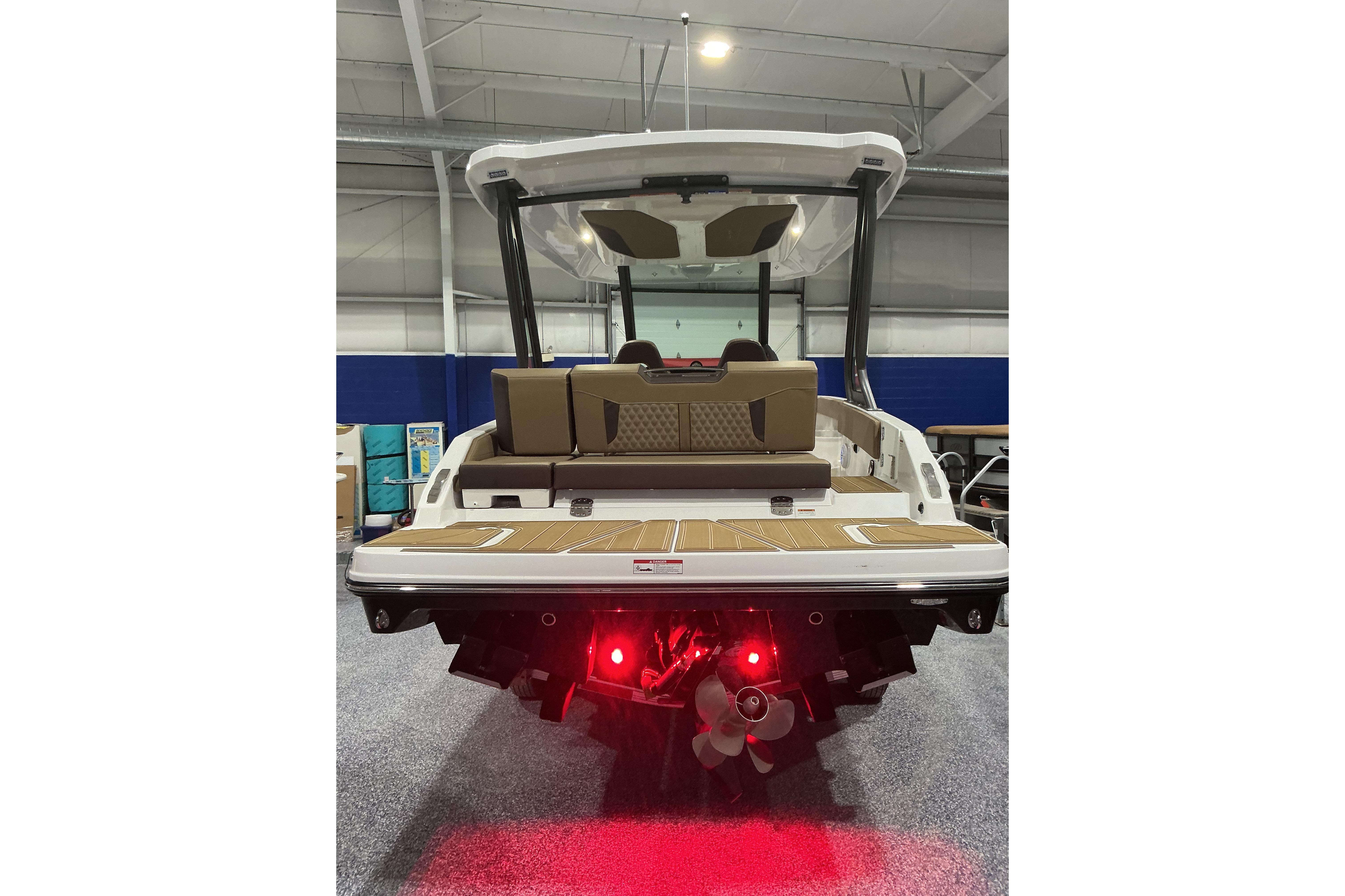 2026 Monterey Elite 25 SD boat rear view with illuminated propeller and spacious deck.