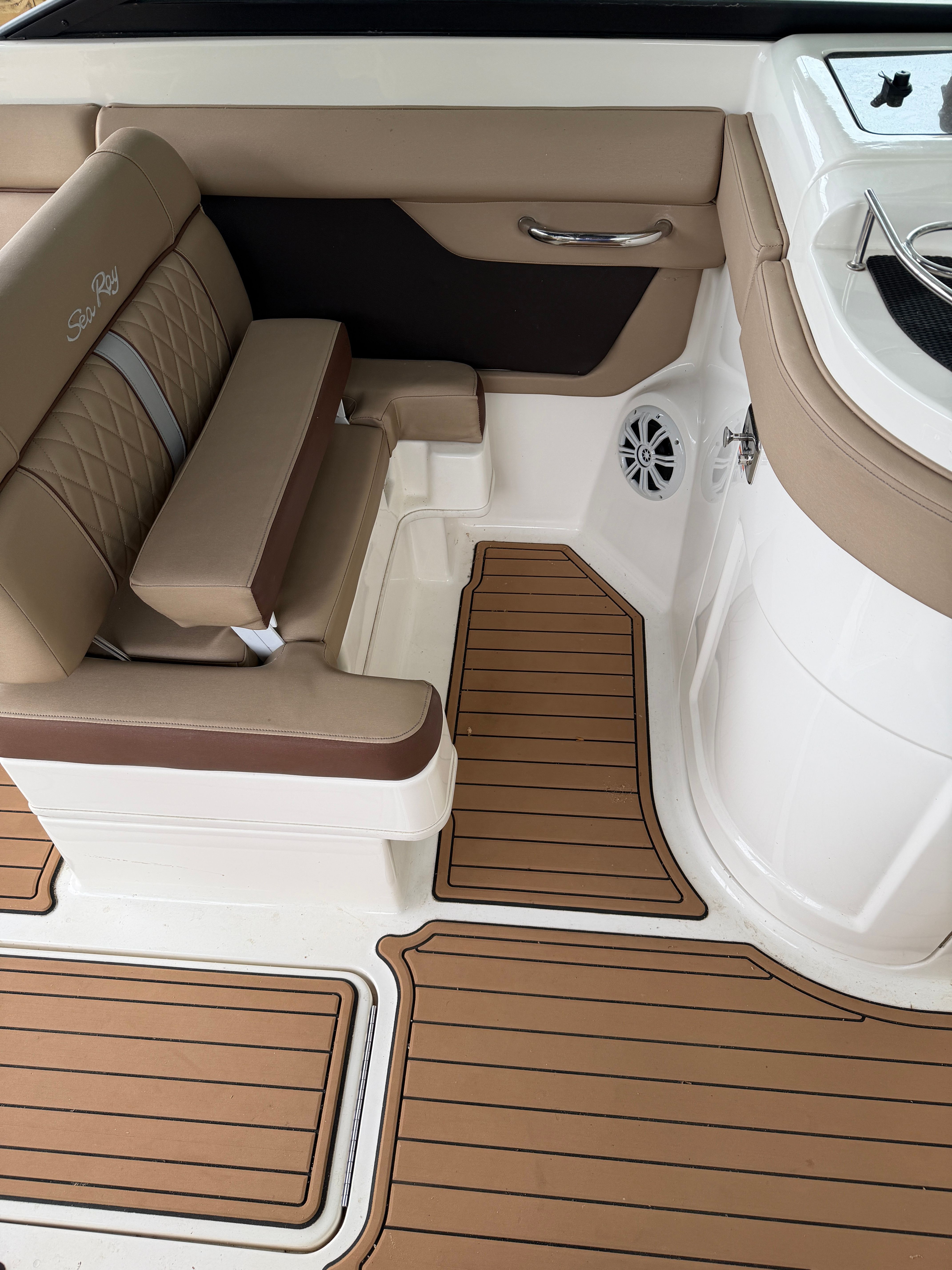 Interior of a 2016 Sea Ray 290 Sundeck with brown seating.
